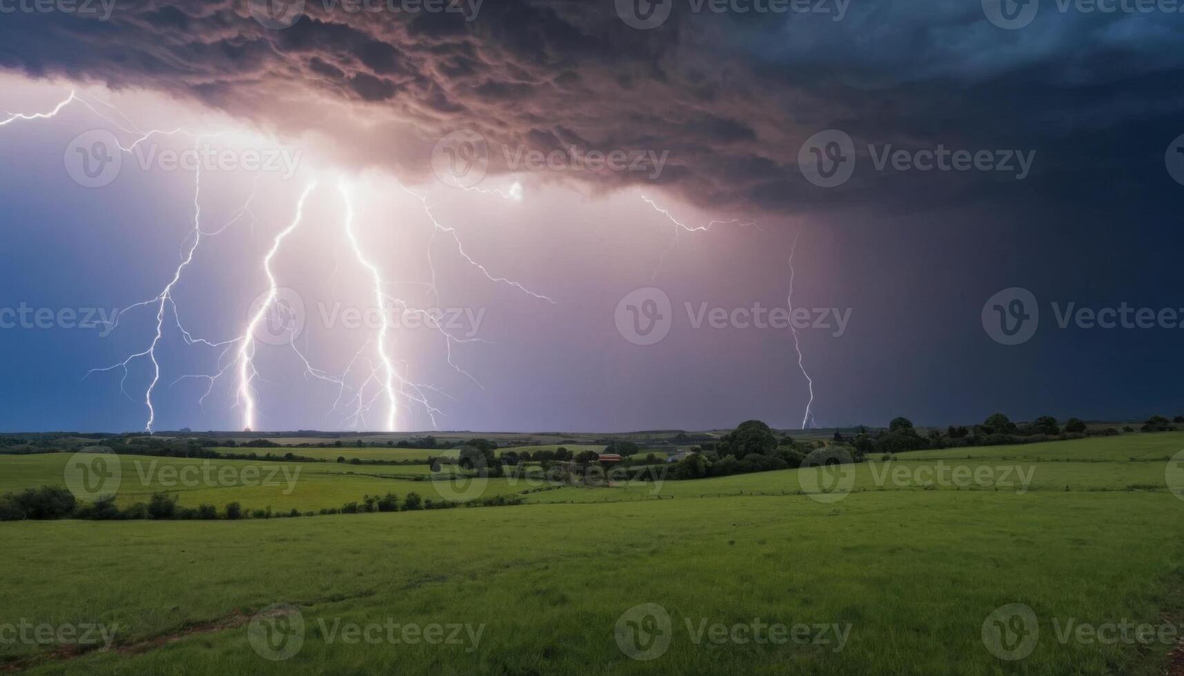 Dramatic Lightning Strikes Over Rolling Green Fields Under Dark Storm Clouds in a Captivating Natural Landscape photo