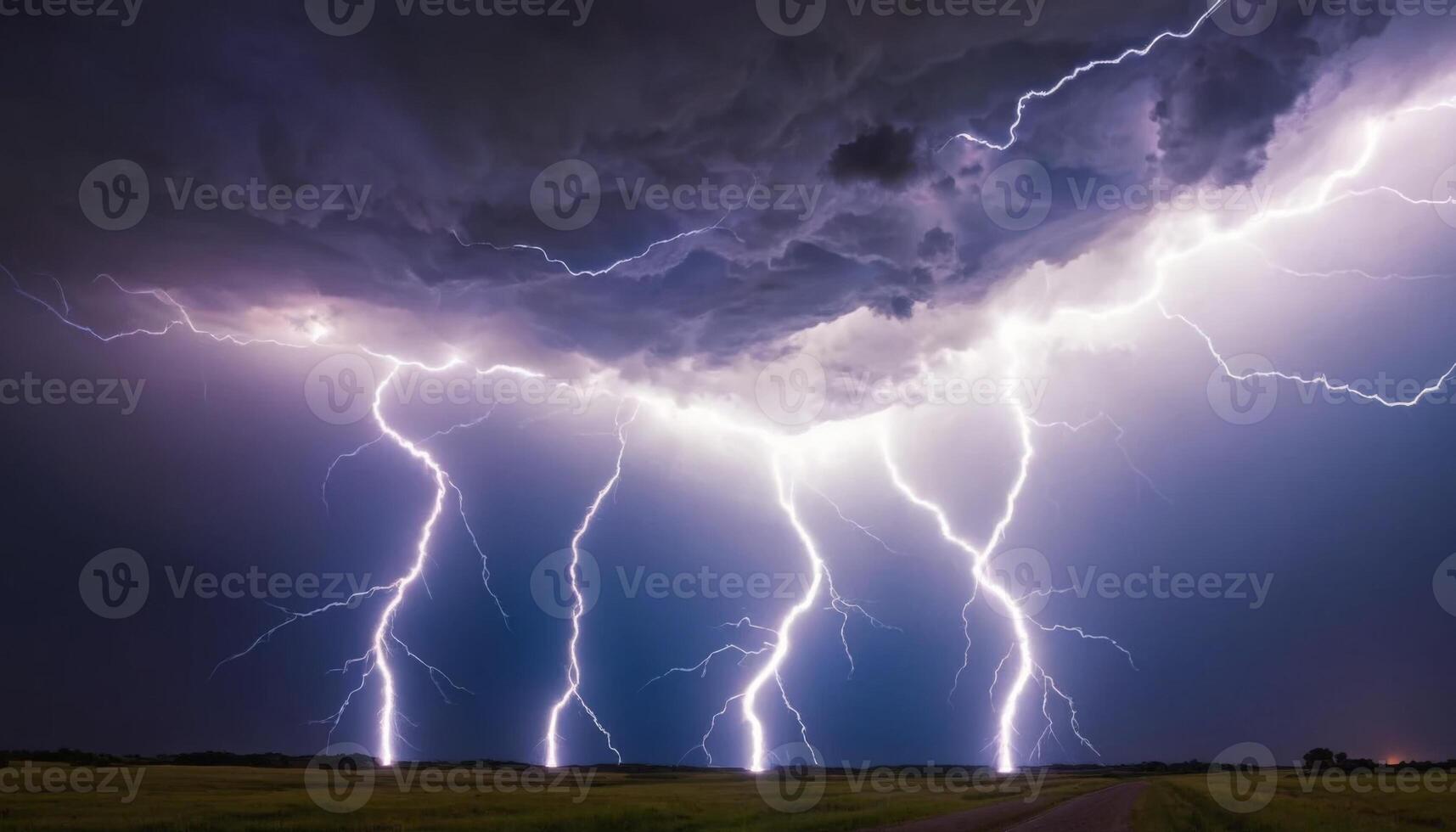 Dramatic Lightning Strikes Illuminating Dark Storm Clouds Over Open Fields in a Scenic Landscape photo