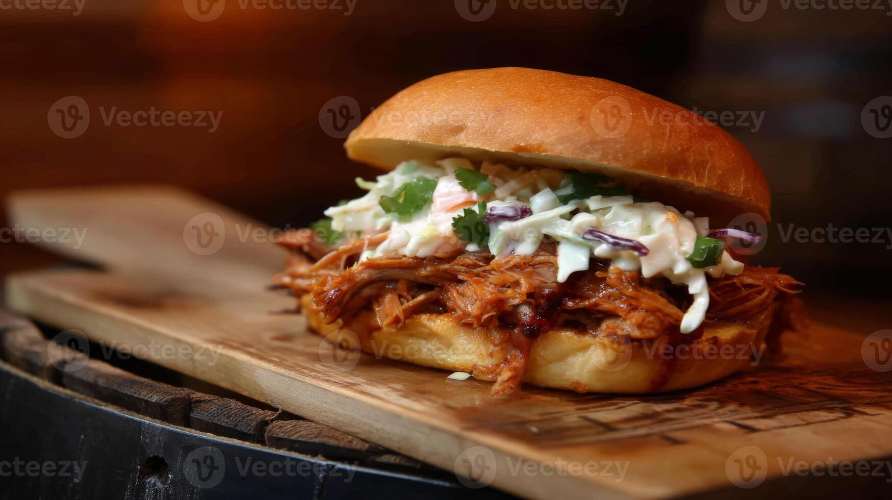 Juicy Pulled Pork Sandwich with Fresh Slaw on Rustic Wooden Board Surrounded by Warm Lighting and Textured Background photo