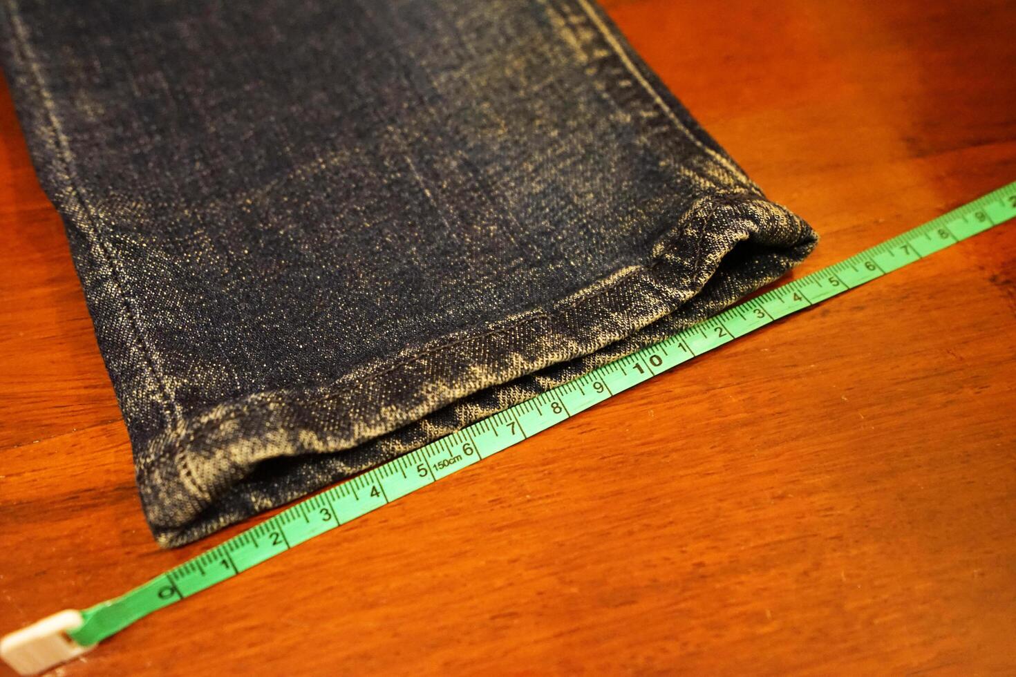 Close up measuring pair of Indigo denim Jeans pants photo