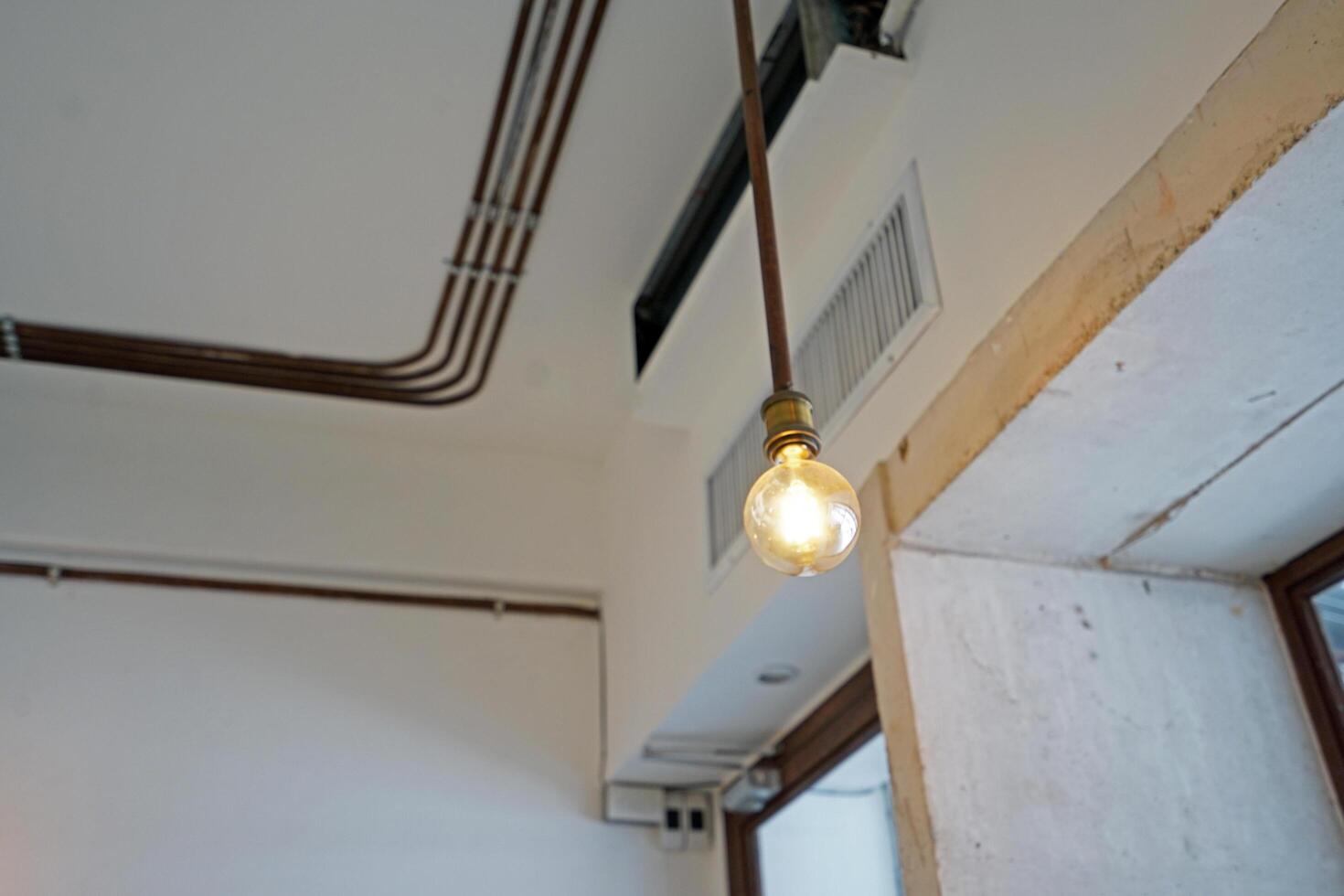 Interior ceiling architecture and design of industrial loft building decorated with modern electric lamps in concrete cement structure photo