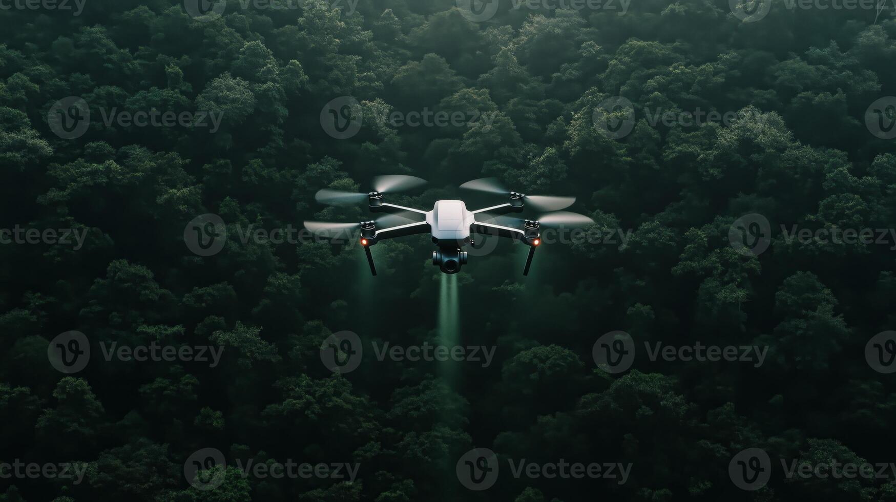 A drone flying over a forest with trees photo