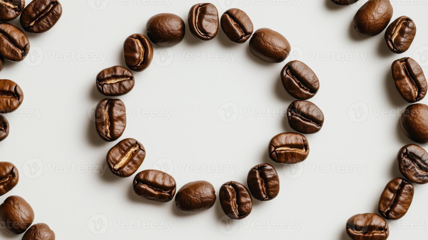 Coffee beans arranged in a circle on a white surface photo