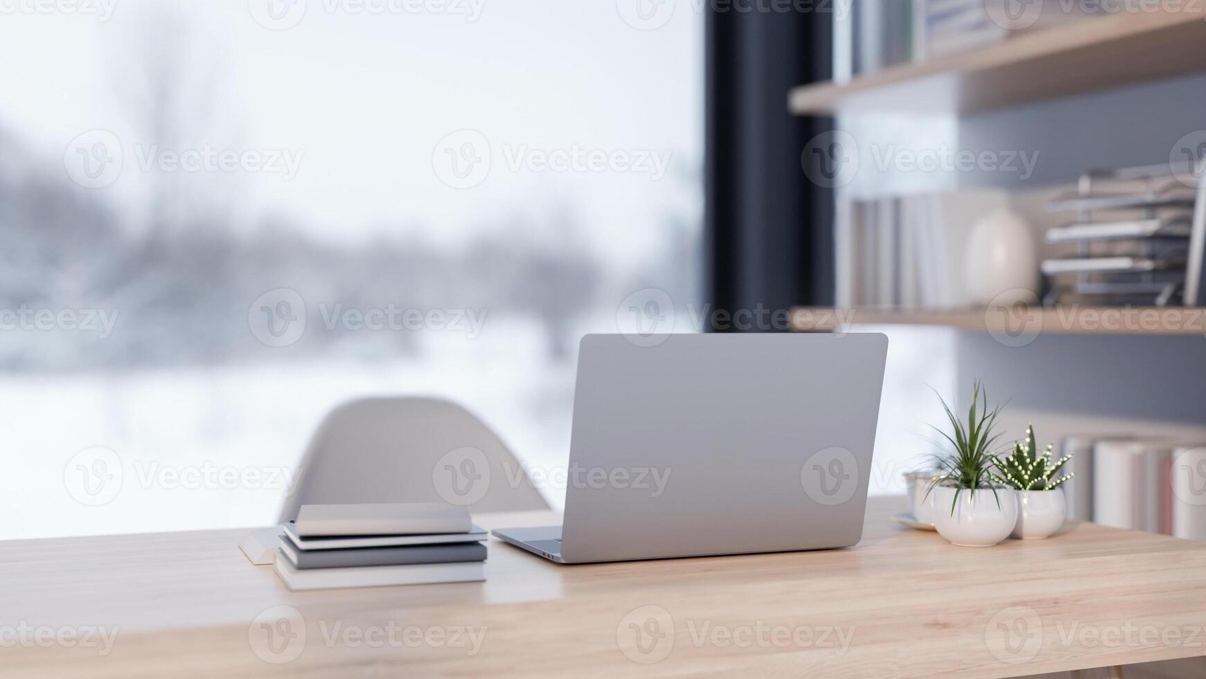 A back view of a laptop placed on a desk in a modern office with a overlooking a snowy winter view. photo