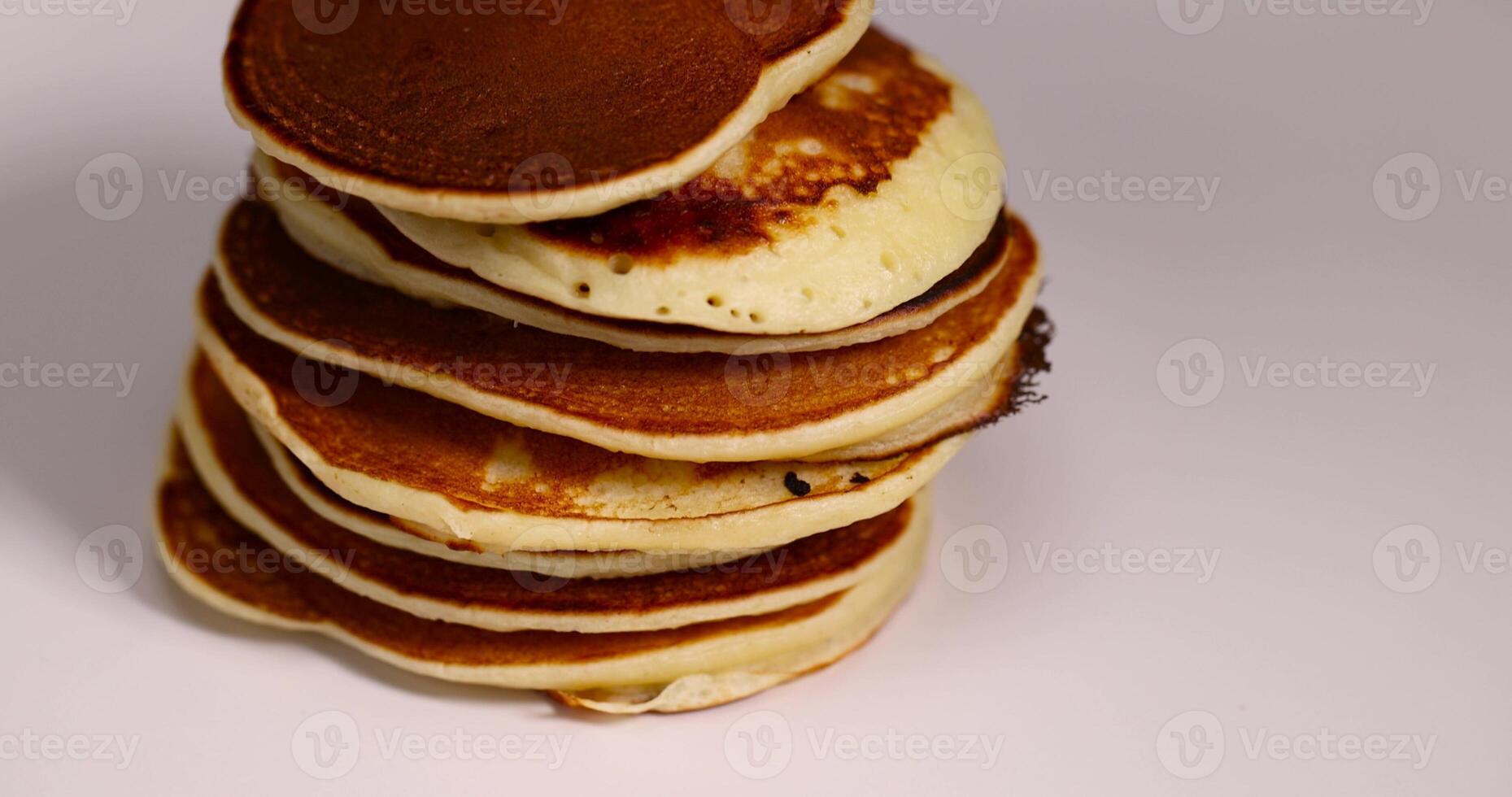 a large number of delicious pancakes stacked together on a white bowl photo