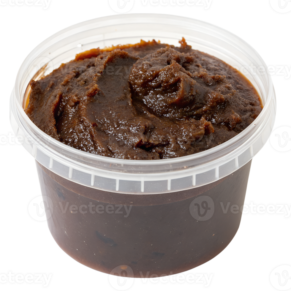 A transparent plastic container with a screw-on lid, filled with thick, dark-brown tamarind paste, isolated on the transparent background png
