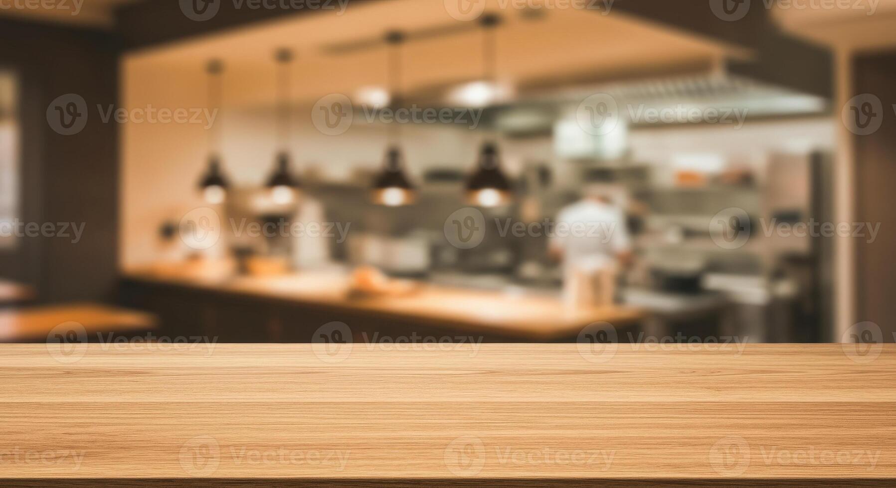 Wood table top and blurred restaurant kitchen photo