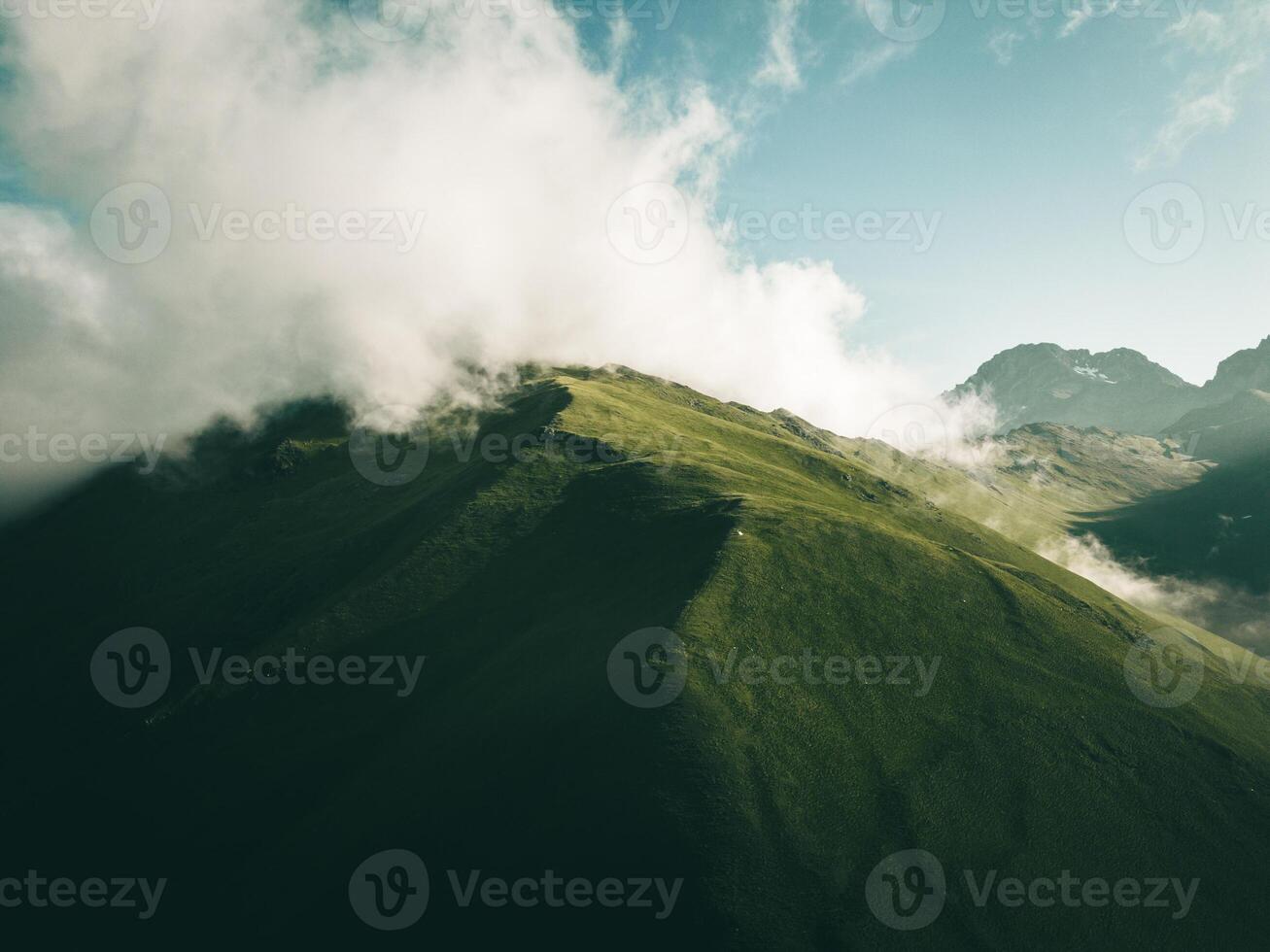 single one tent on hilltop with greeny aucasus mountains panorama. Green camping tent on top of mountain with amazing sunrise on background. Time spending on fresh air. Traveling concept photo