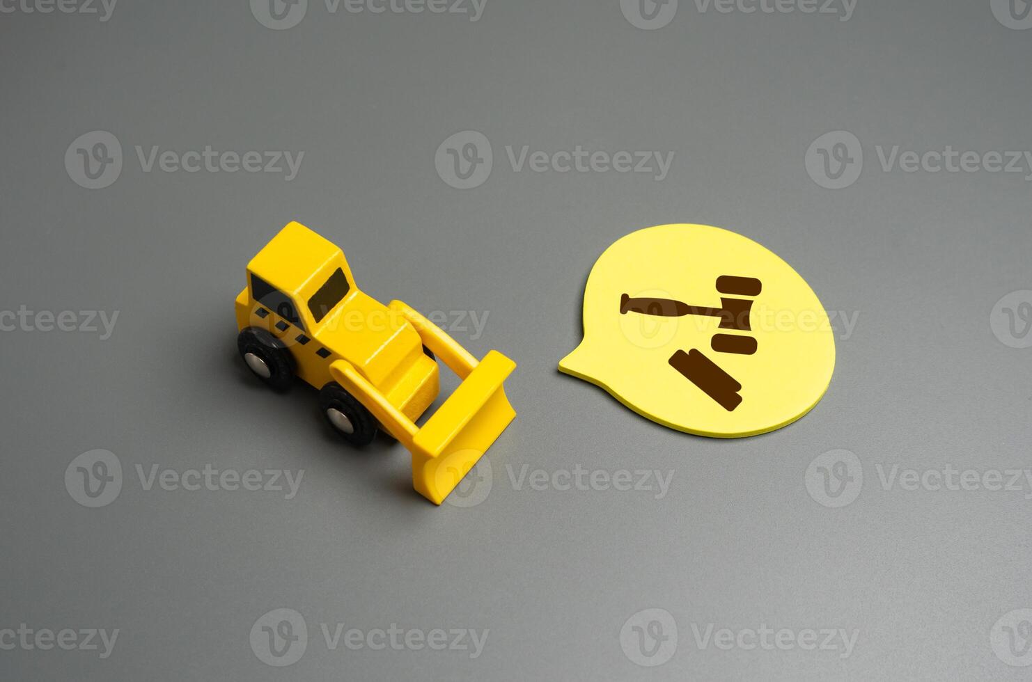Bulldozer and the symbol of the judge's hammer. Court decisions on demolition and construction photo