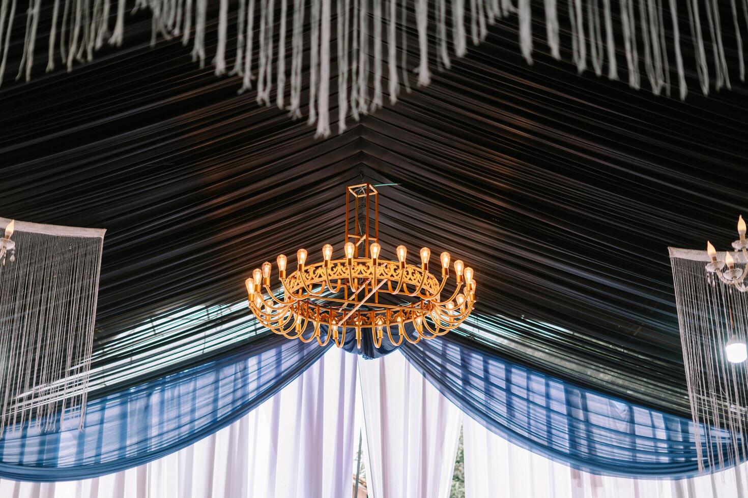 Elegant Interior, Chandelier and Draped Fabrics for Event Decoration photo