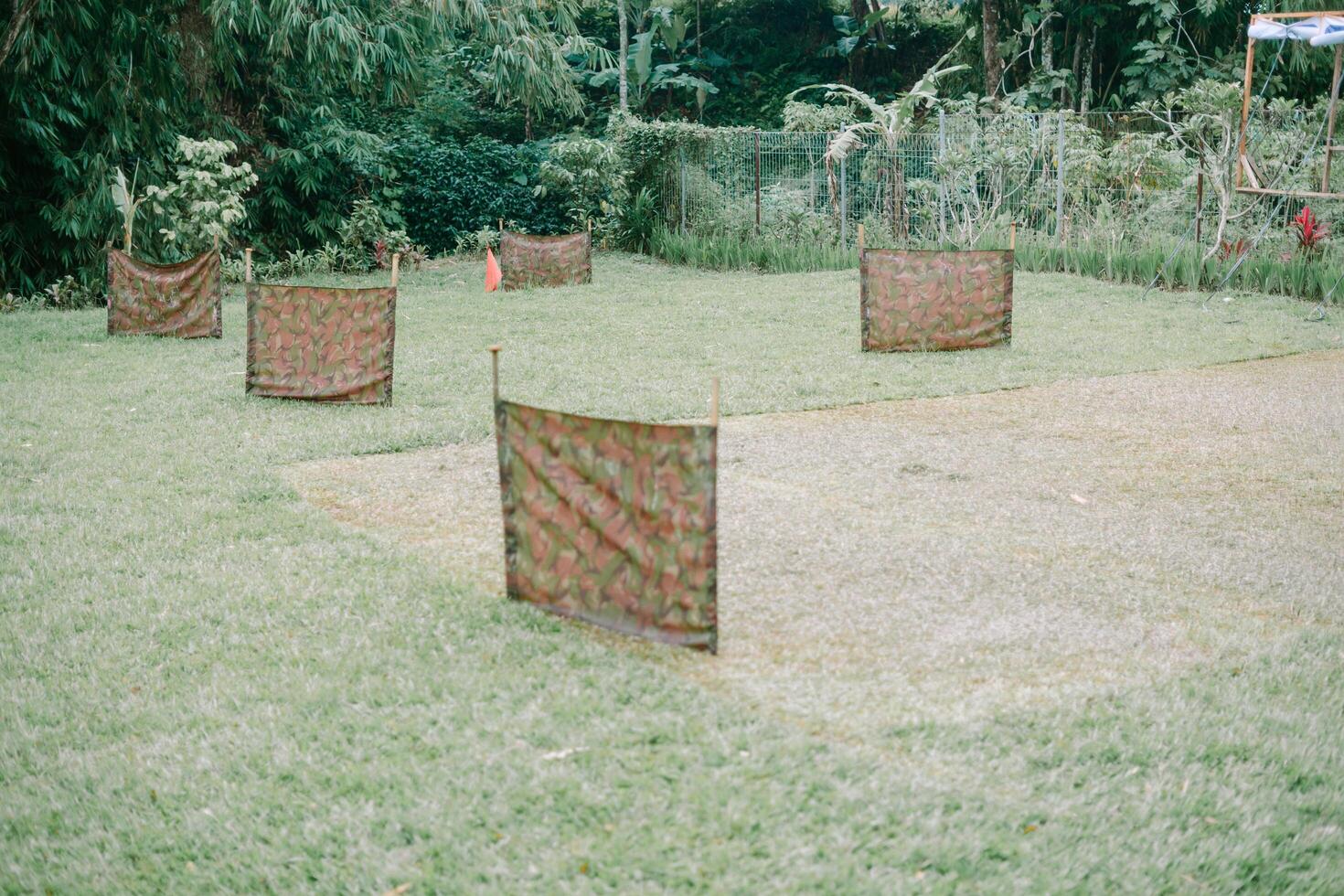 Outdoor Obstacle Course Setup with Camouflage Screens and Natural Greenery photo