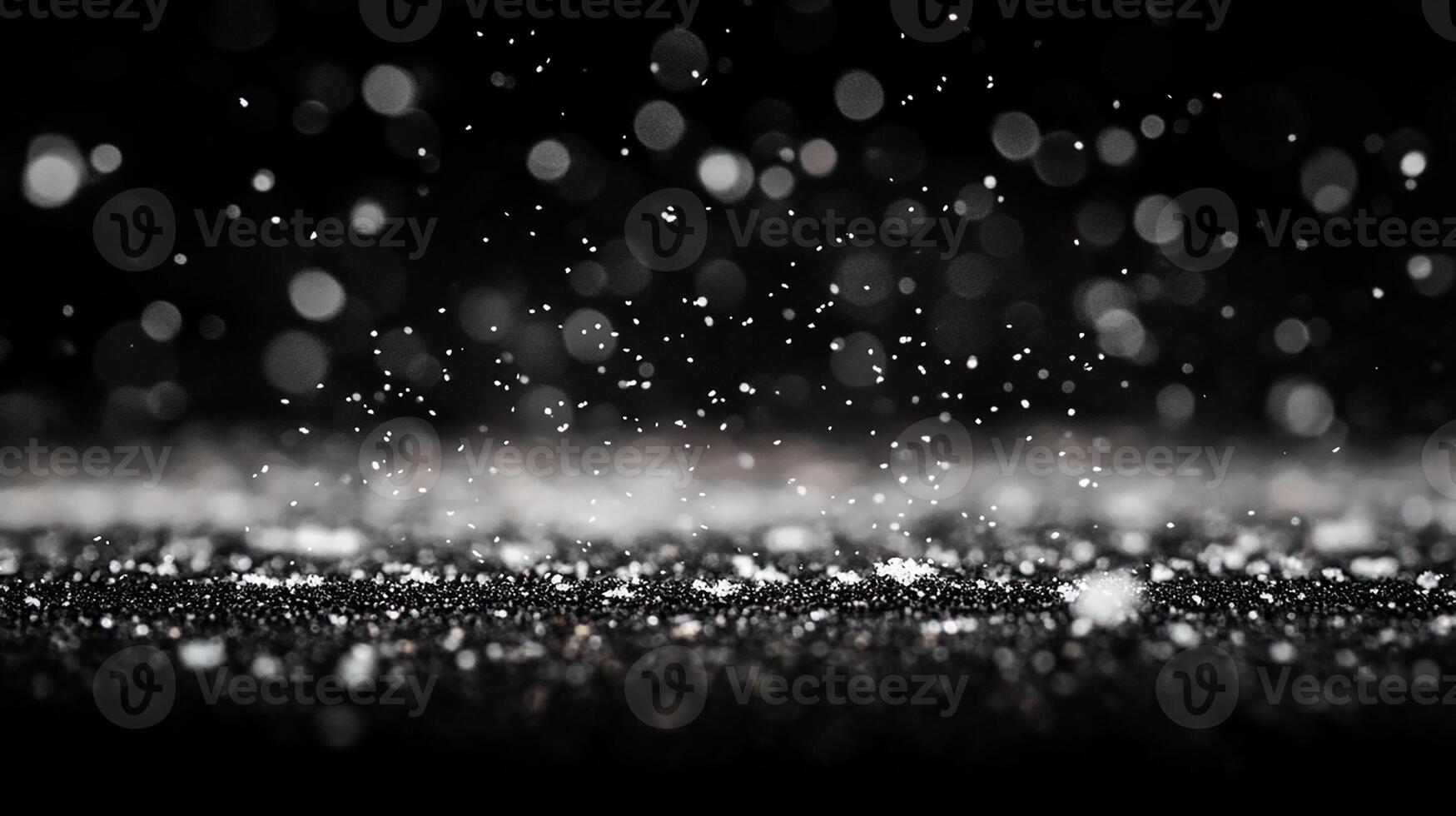 Snowflakes Gently Falling Against a Black Background with Bokeh photo