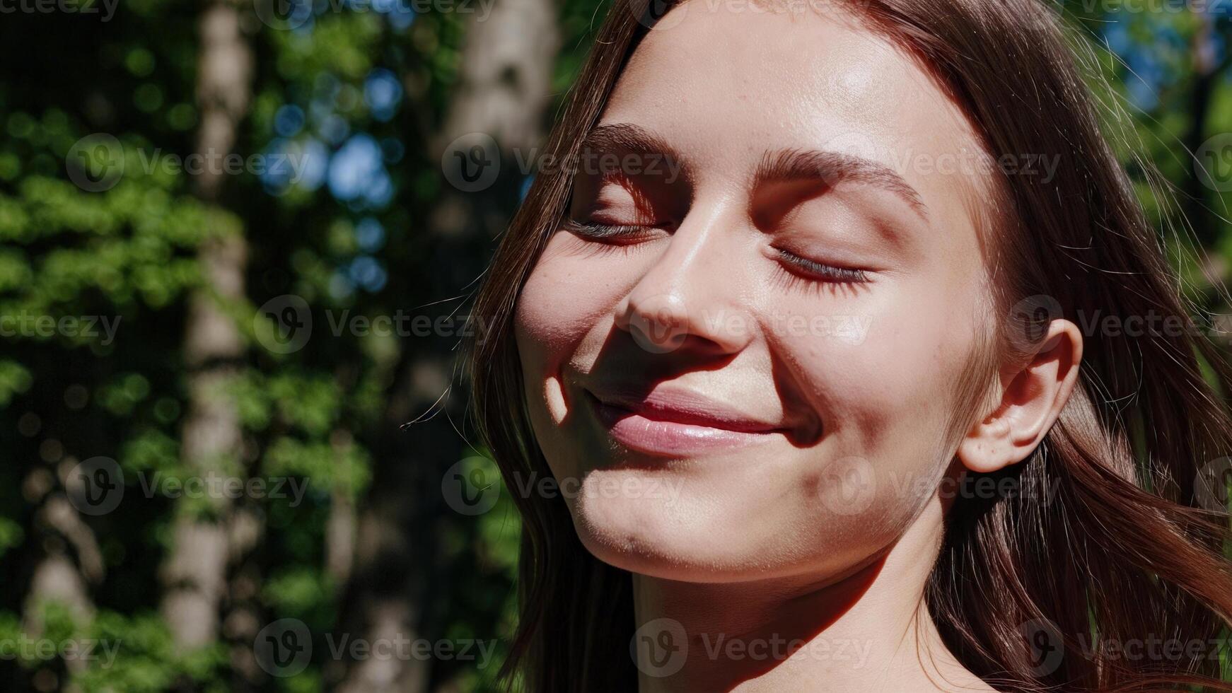 A woman is smiling while looking at the camera photo