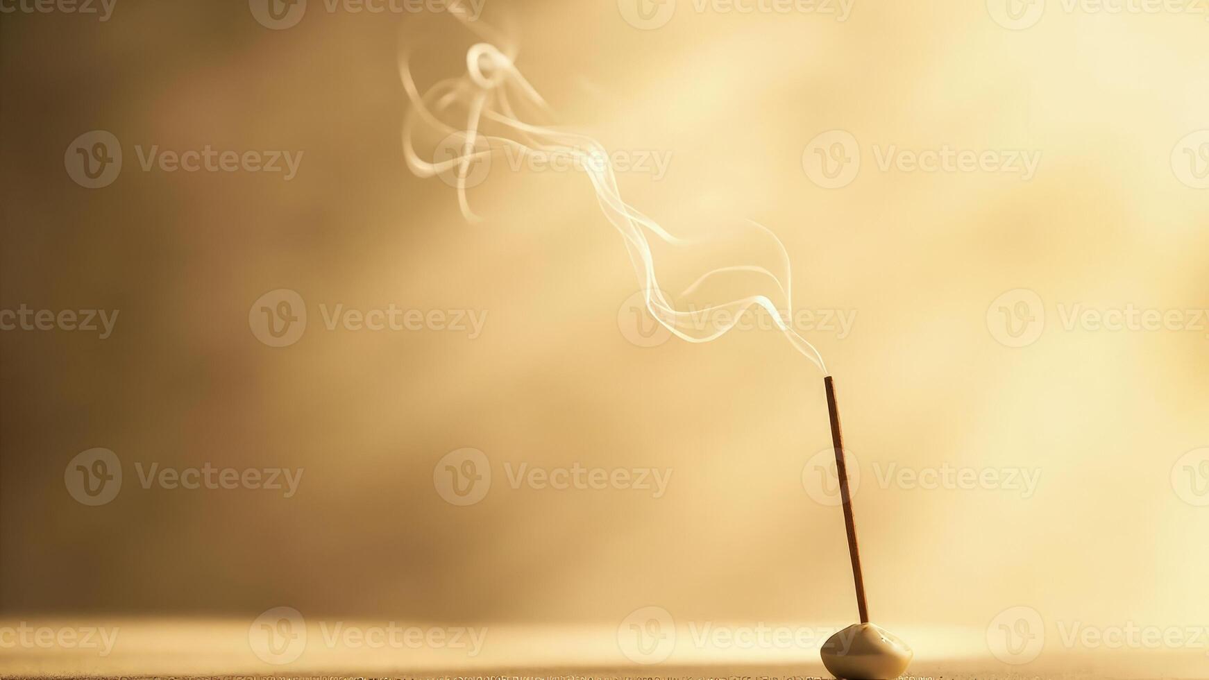 An incense stick with smoke coming out of it photo