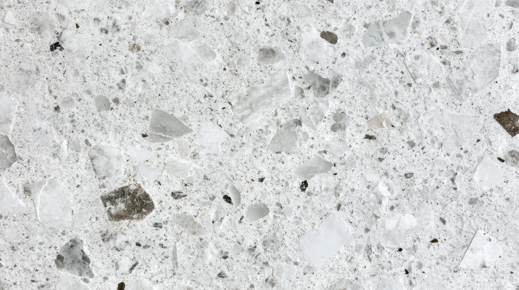 Close-up view of white terrazzo texture surface with mixed stone fragments photo