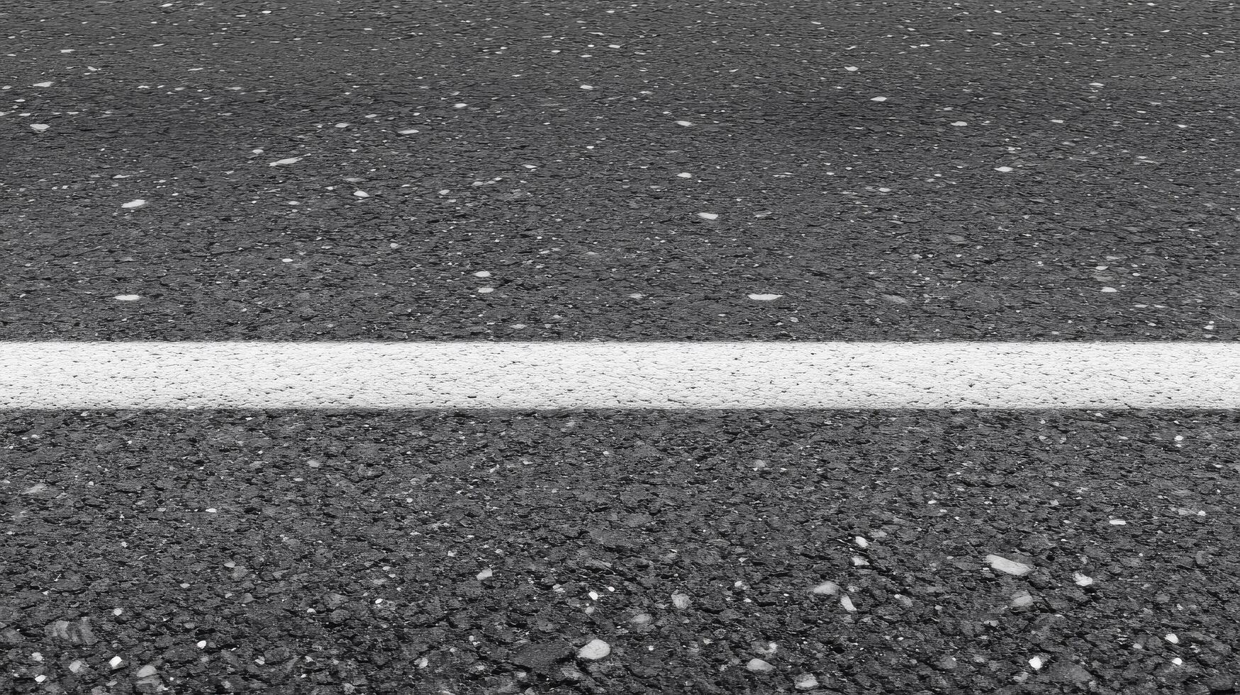 Close-up of asphalt road with white line as urban infrastructure concept photo