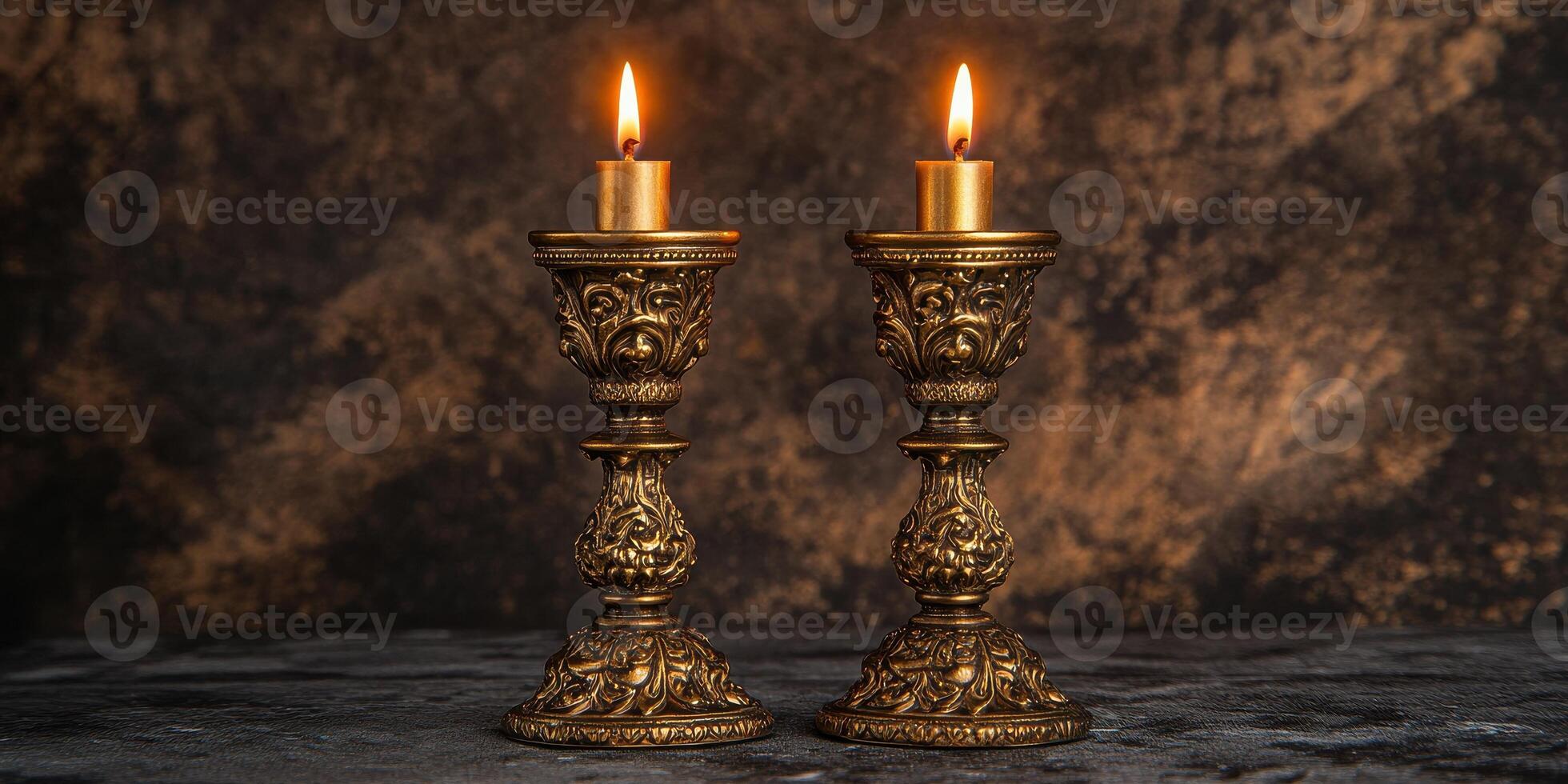 Elegant vintage brass candle holders with lit candles on rustic background photo
