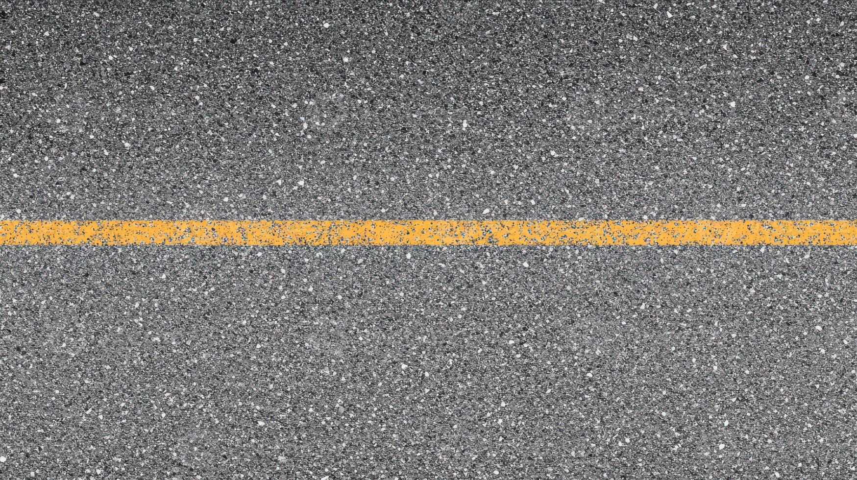 Single yellow line on asphalt road surface for transportation and urban design concepts photo