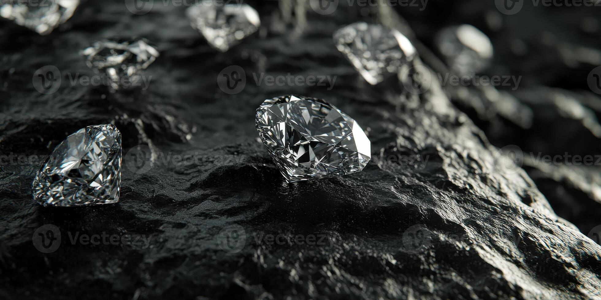 Shiny diamonds reflecting light on rough black surface with dark background photo