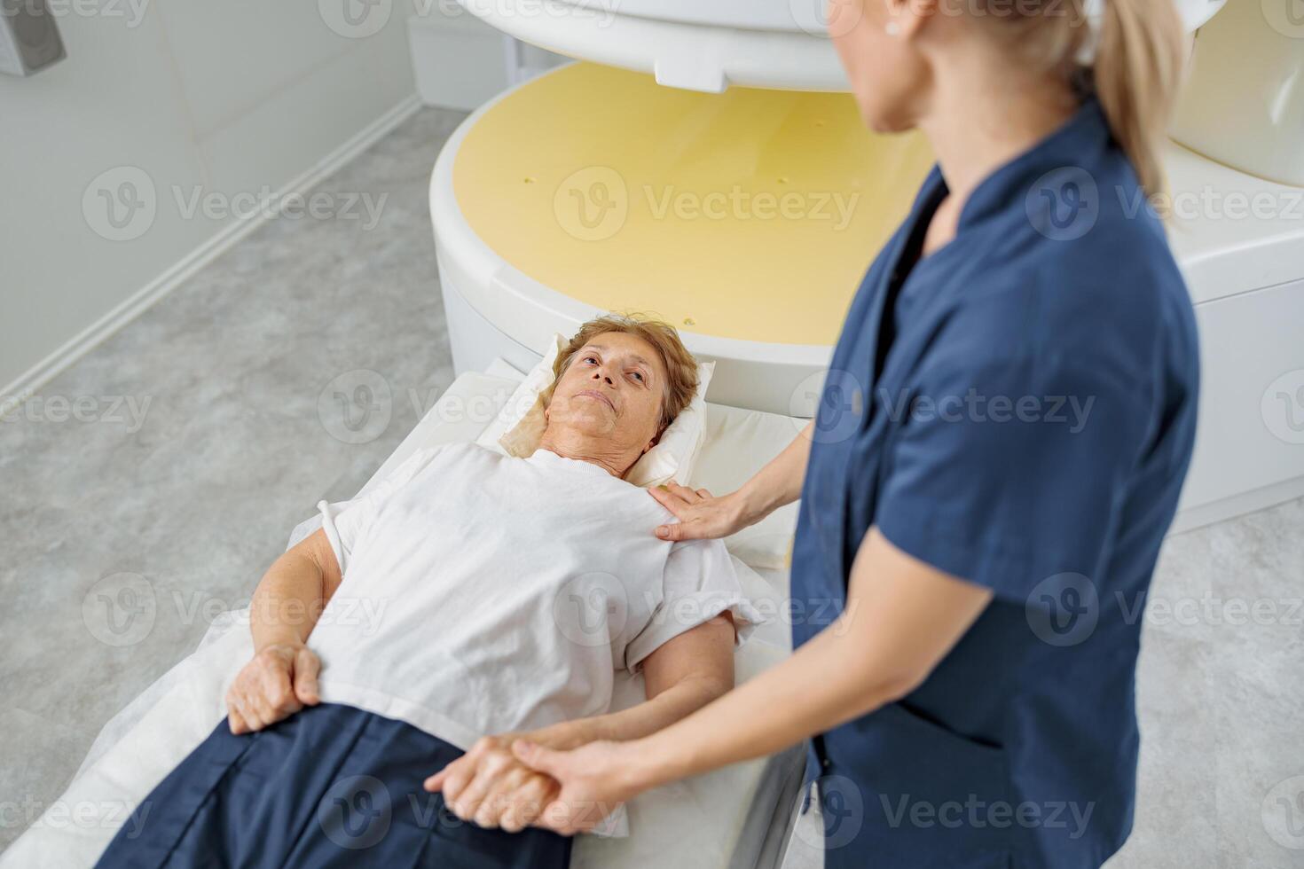 Doctor radiologist comforting a patient before the procedure of MRI or CT or PET Scan photo