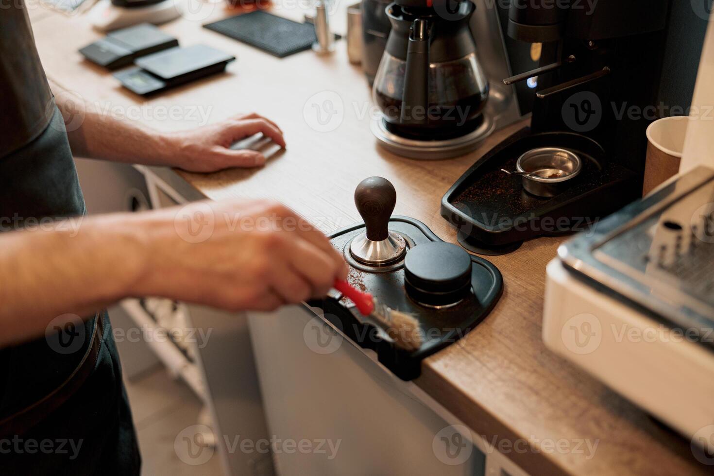 Male coffee shop owner cleaning up counter for service to customer photo