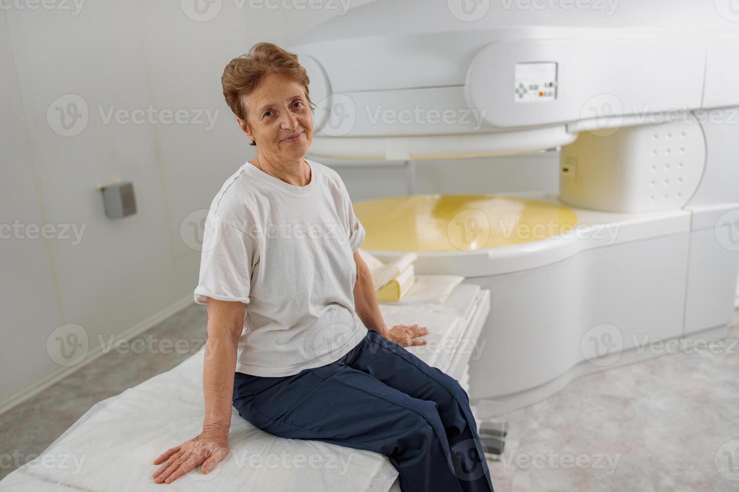 Happy woman patient looking camera after doing procedure of MRI or CT Scan in medicine clinic photo