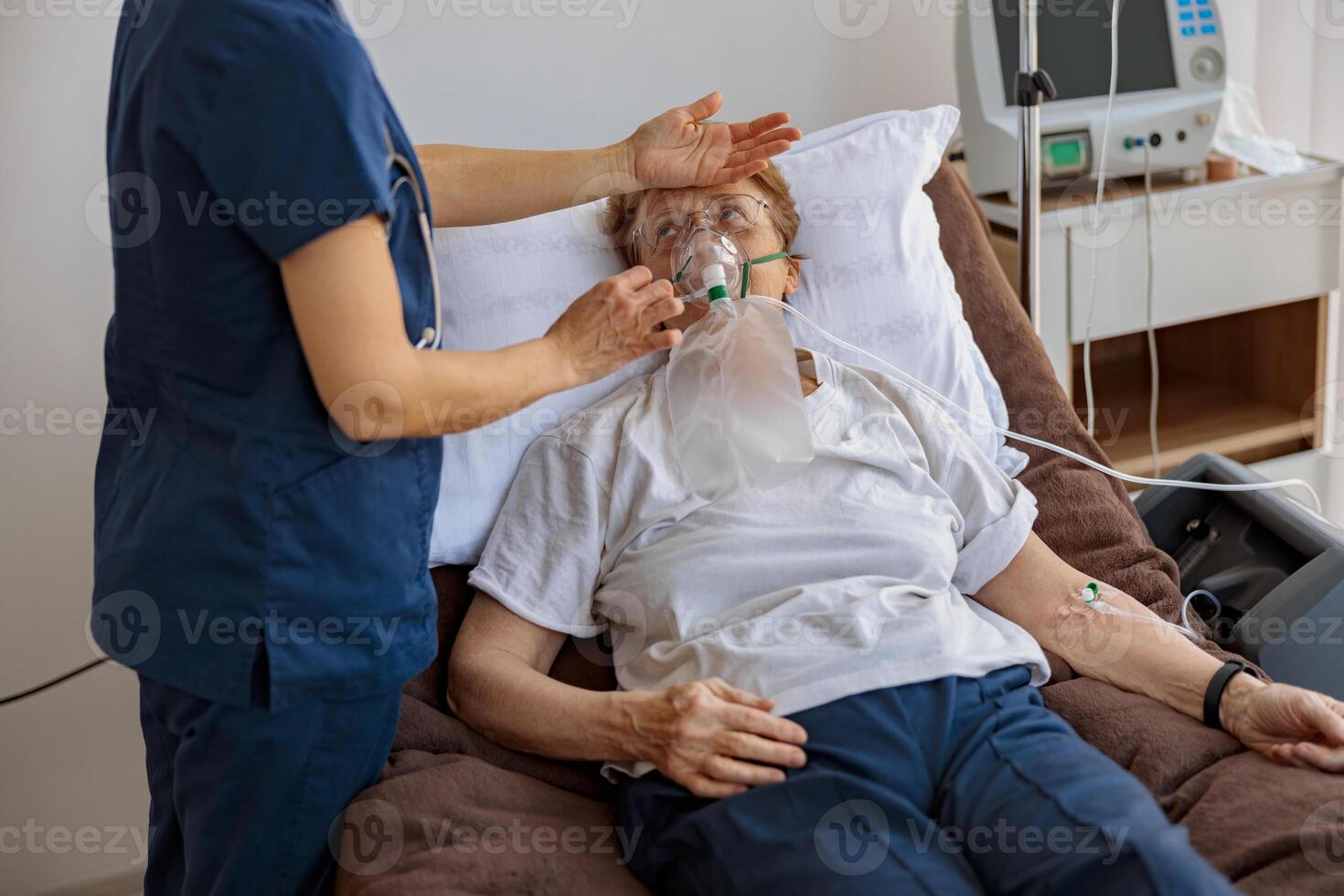 Doctor putting on a breathing mask and control temperature on a female patient with covid-19 photo