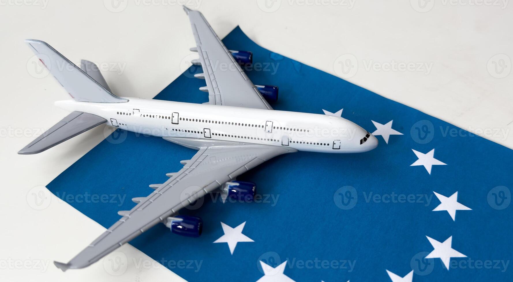 Flag of European Union and toy airplane. Flight travel concept photo