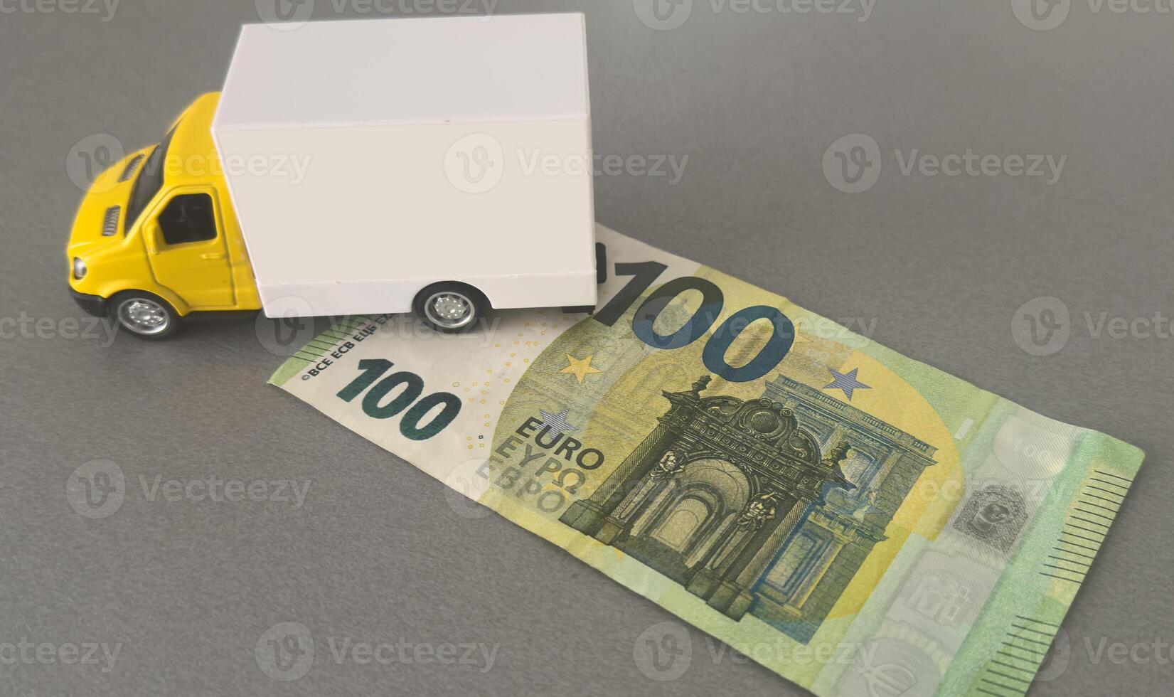 Toy car truck with money isolated on background photo