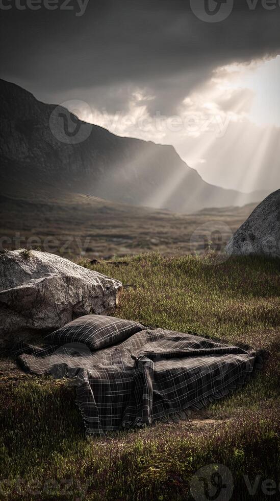 Mountains and plaid bedding under dramatic cloudy sky with sun rays, nature scene photo