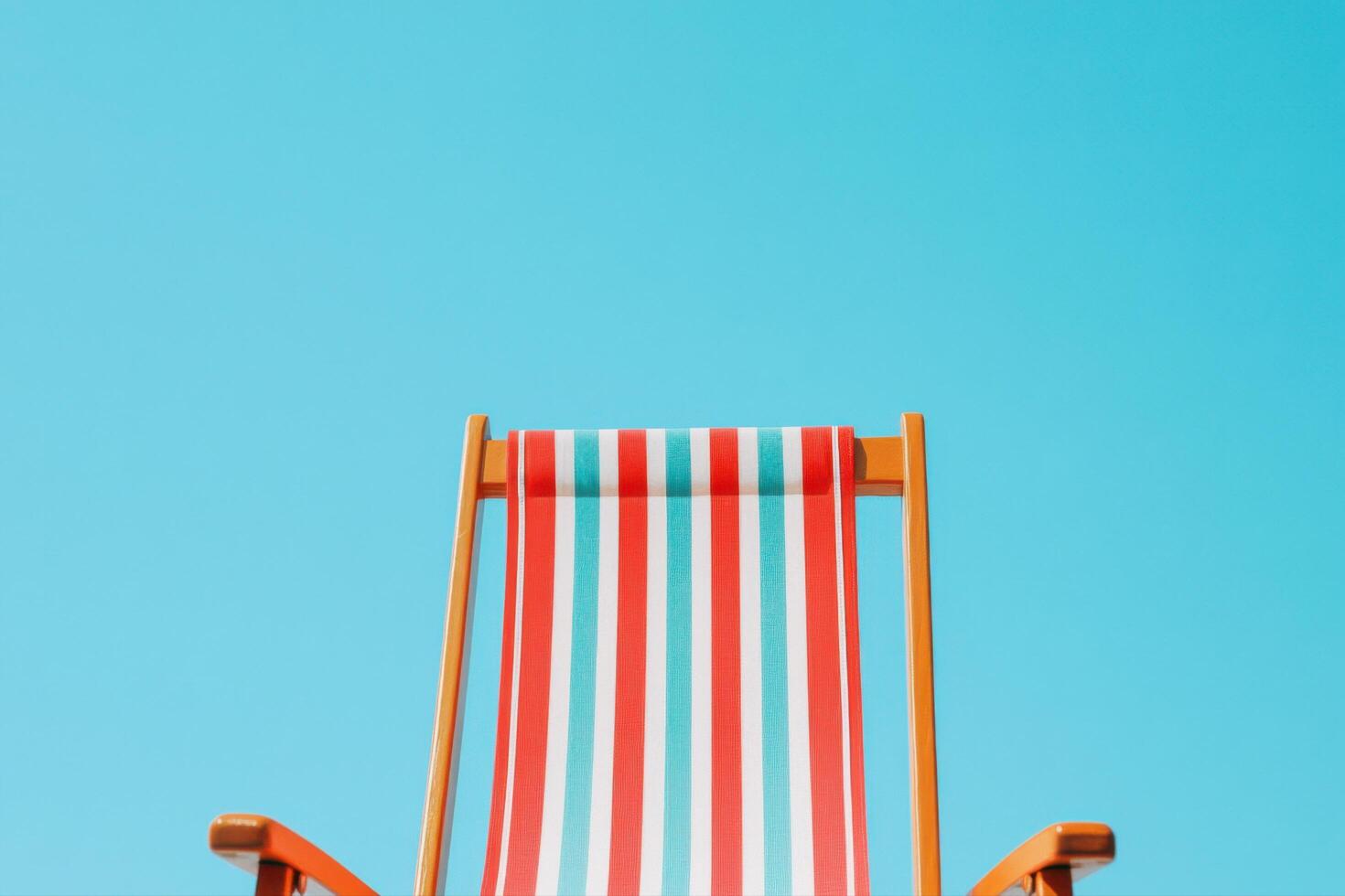 Striped Beach Chair Under Sunny Sky Perfect Summer Relaxation photo