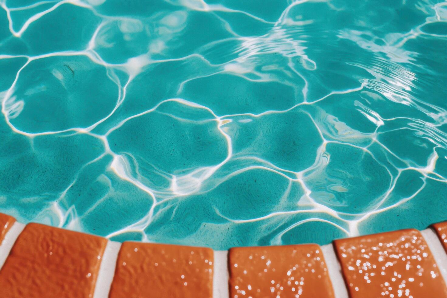Turquoise Pool Water with Orange Tile Edge A Summer Day's Delight photo