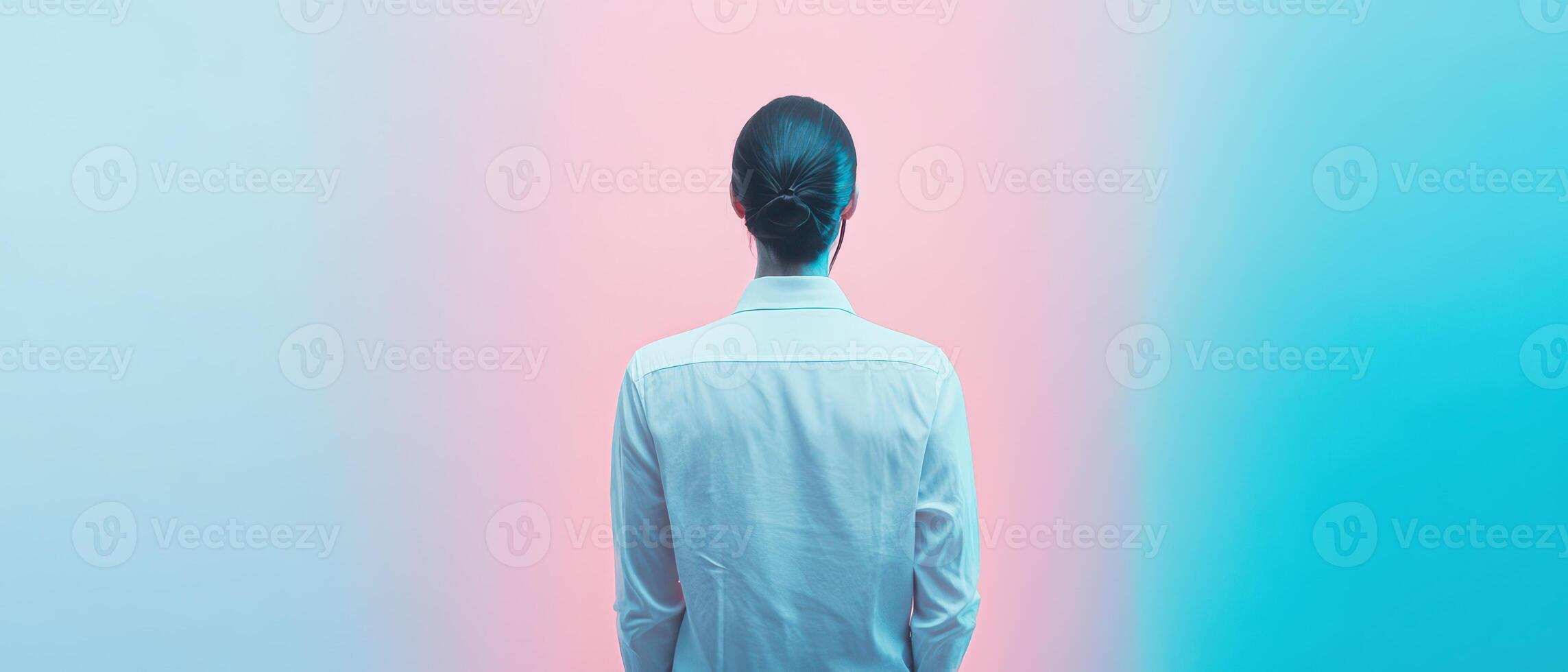 Individual standing in front of a pastel backdrop photo
