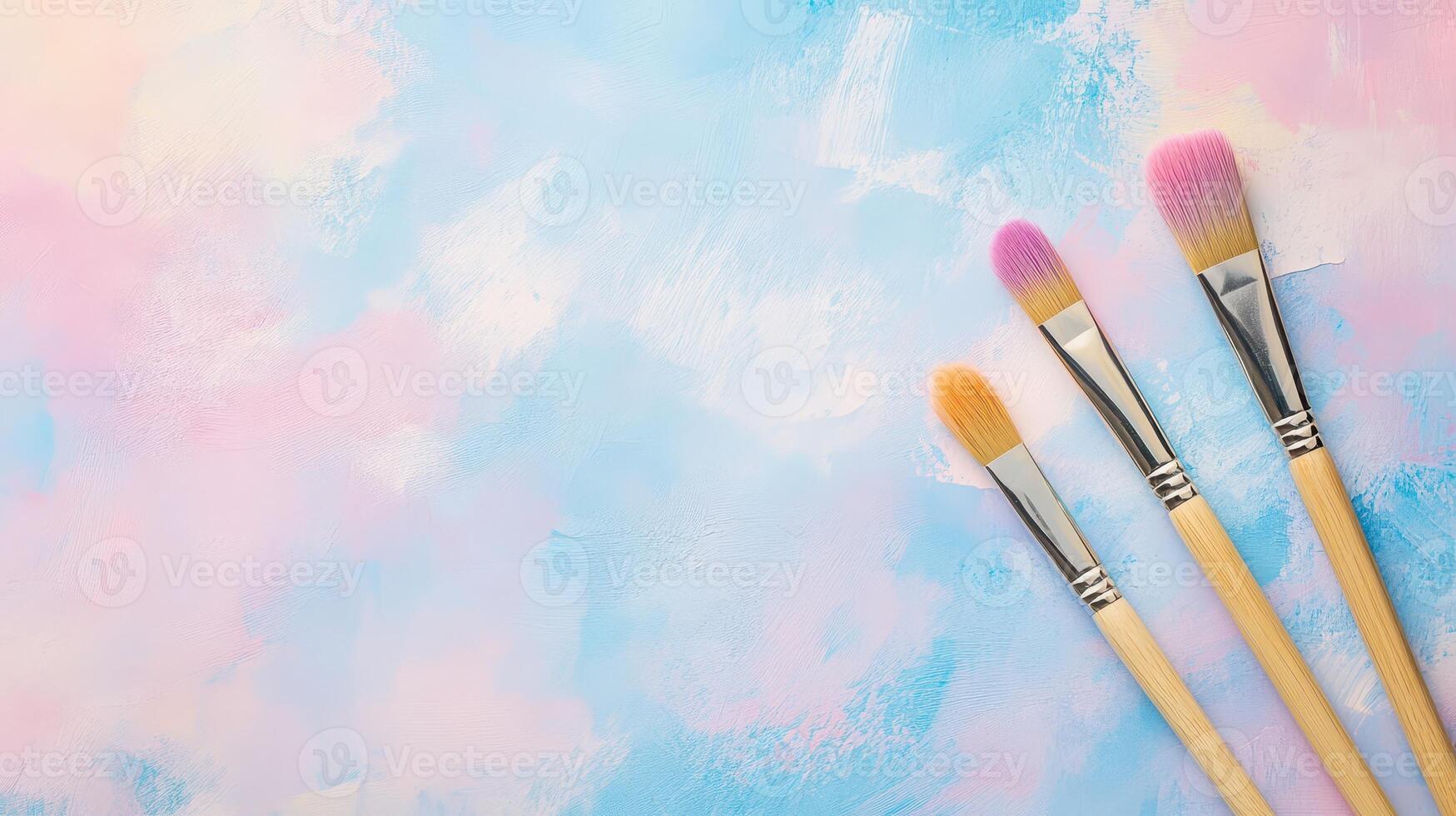 Colorful paintbrushes on pastel background photo