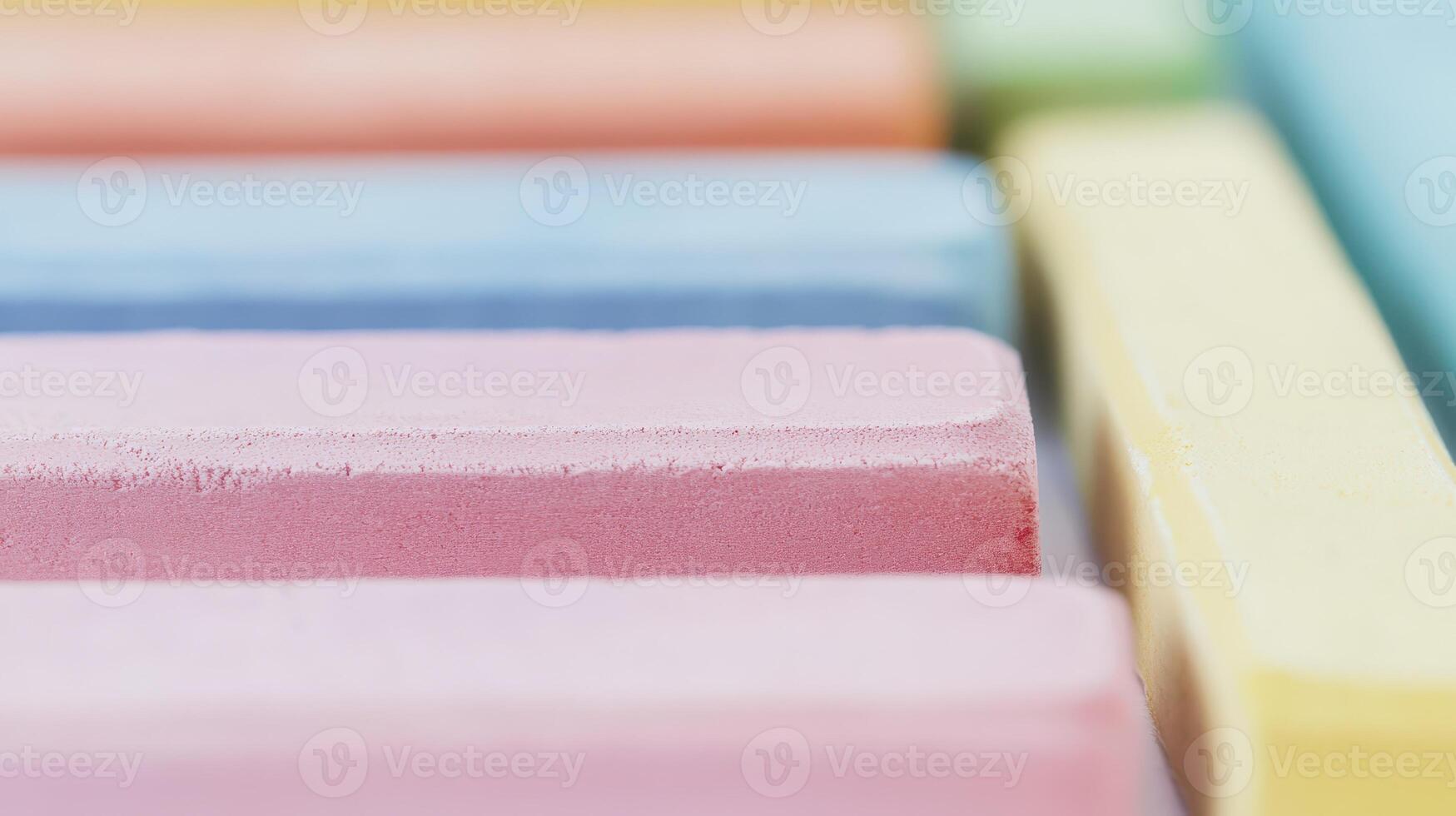 Colorful chalk arranged in neat rows on a surface photo