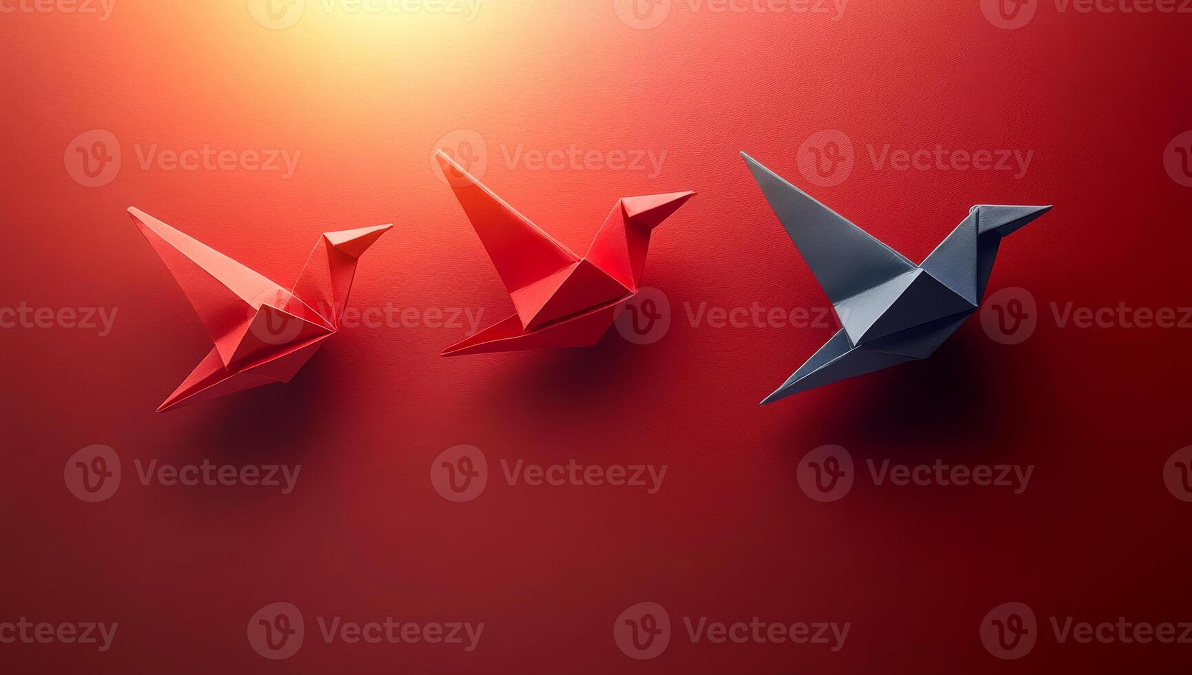 Colorful origami birds displayed on wall. Three origami birds in red and blue are artistically arranged on a wall, creating an engaging visual display. photo