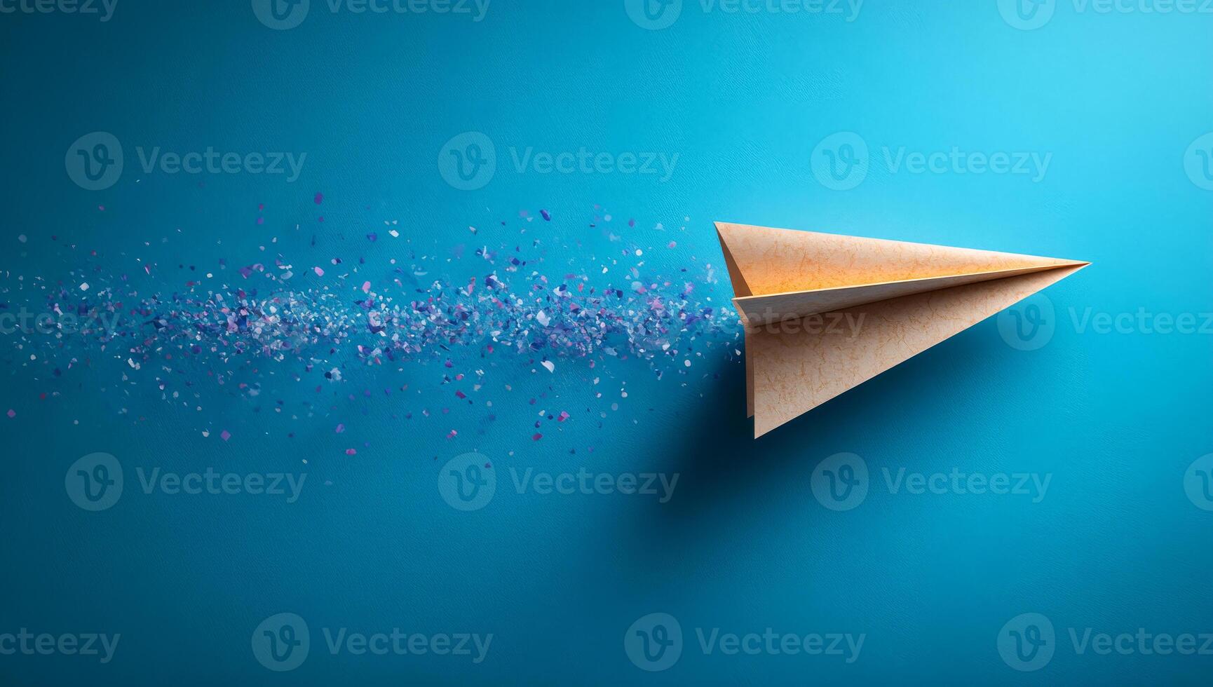 Paper plane in bright sparks. A paper airplane soars across a bright blue background, leaving a trail of colorful particles in its wake. photo