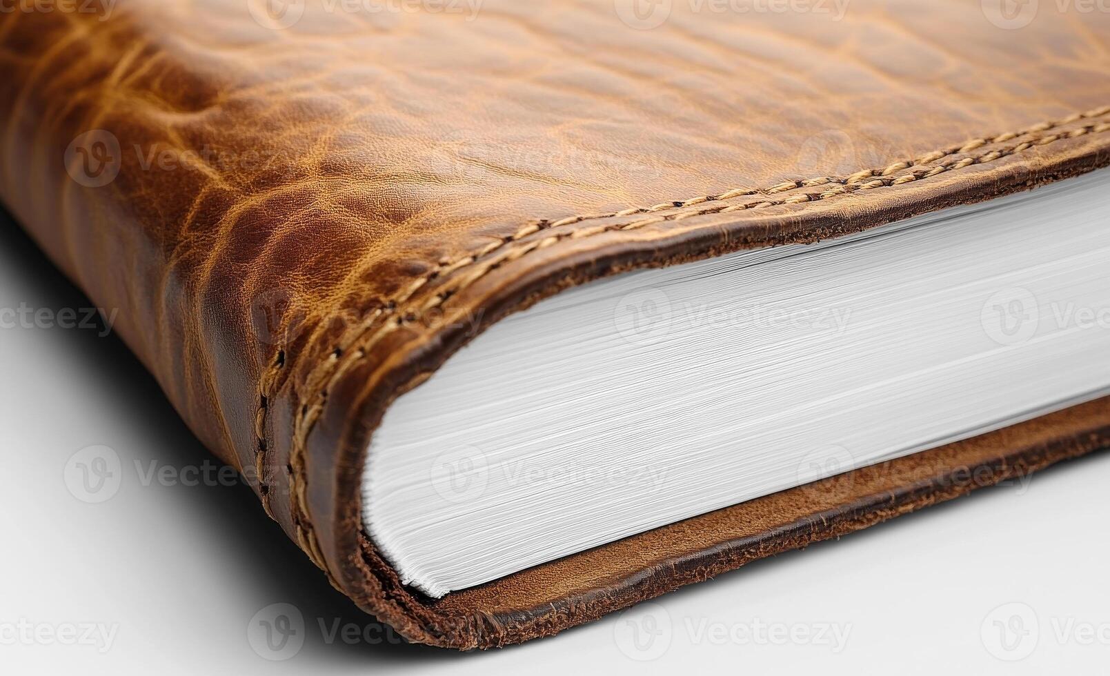 Textured leather journal. A close-up view of a leather-bound journal showcasing its textured cover and crisp, white pages ready for writing. photo