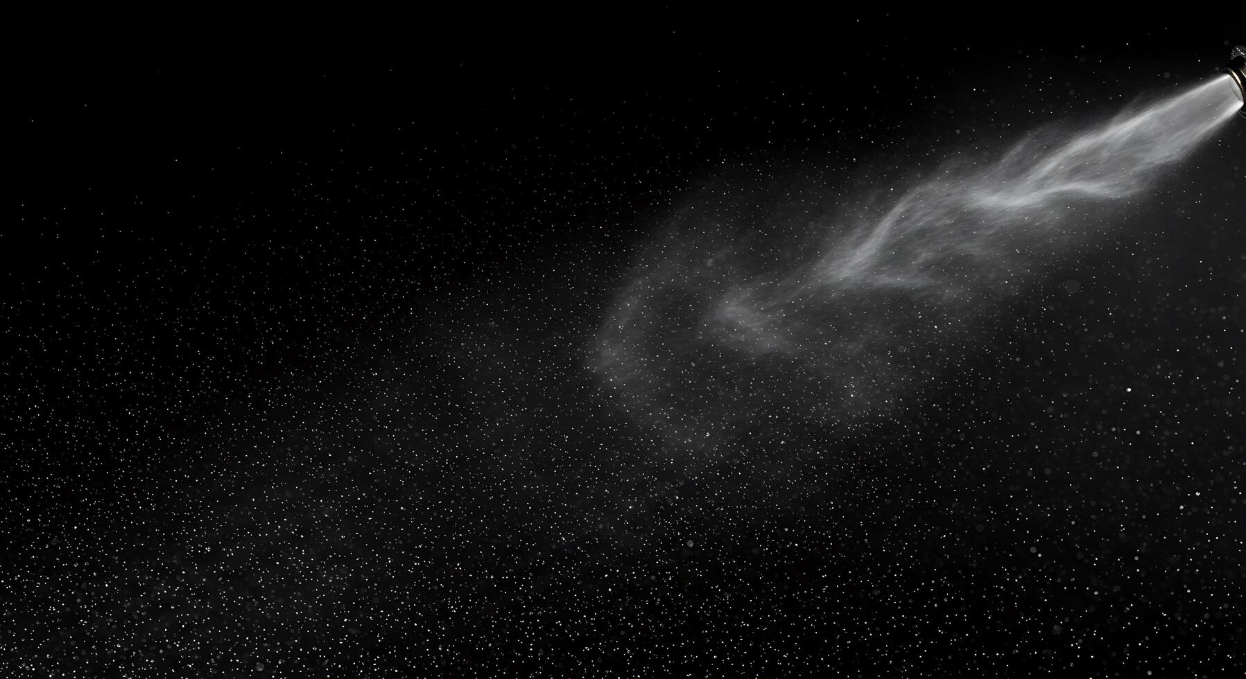 A spray of water is being sprayed on a black background photo