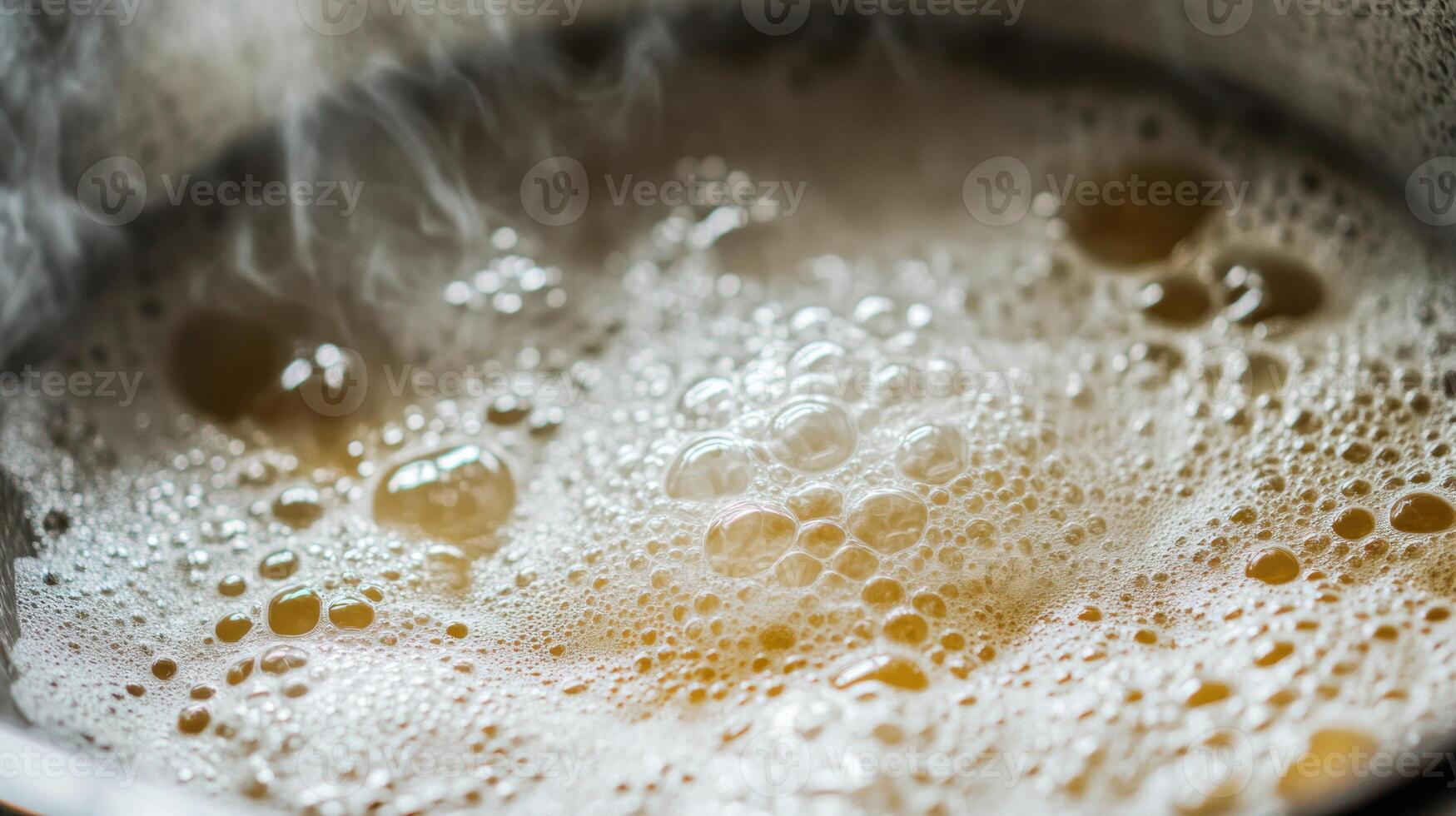 Boiling liquid in a pot, producing bubbles photo