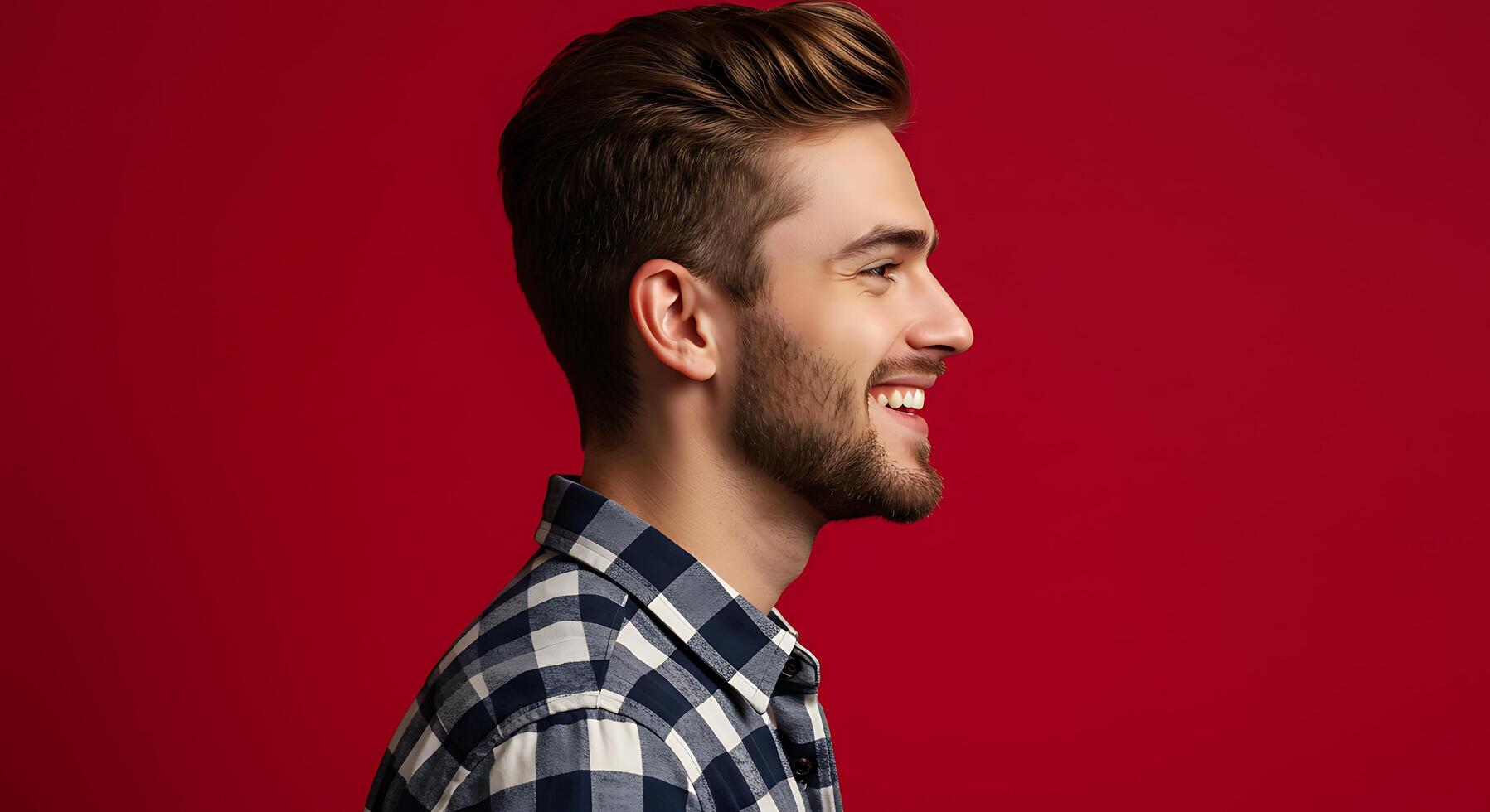 A man with a beard and a checkered shirt is smiling photo