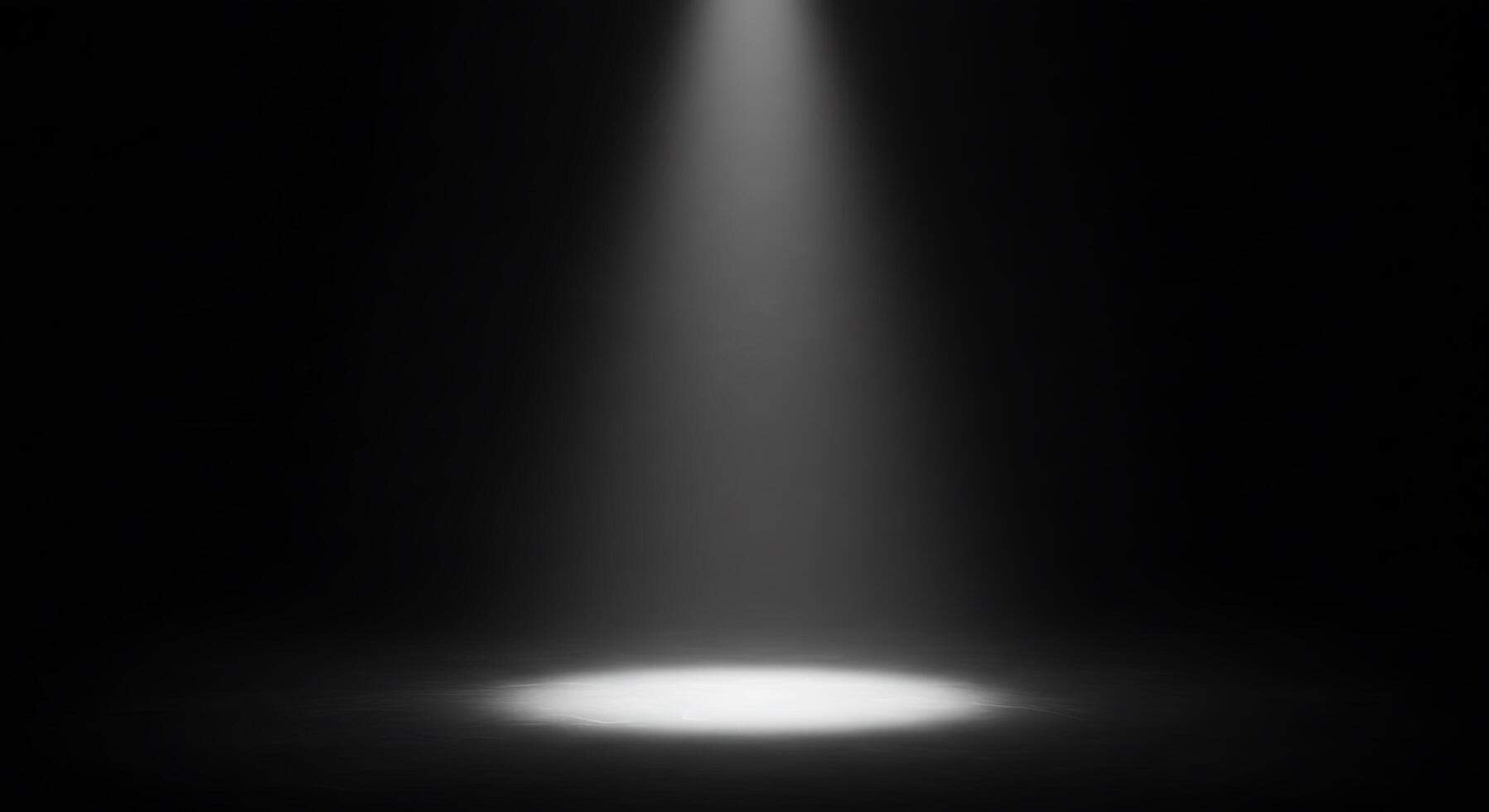 A spotlight shines on a black background photo