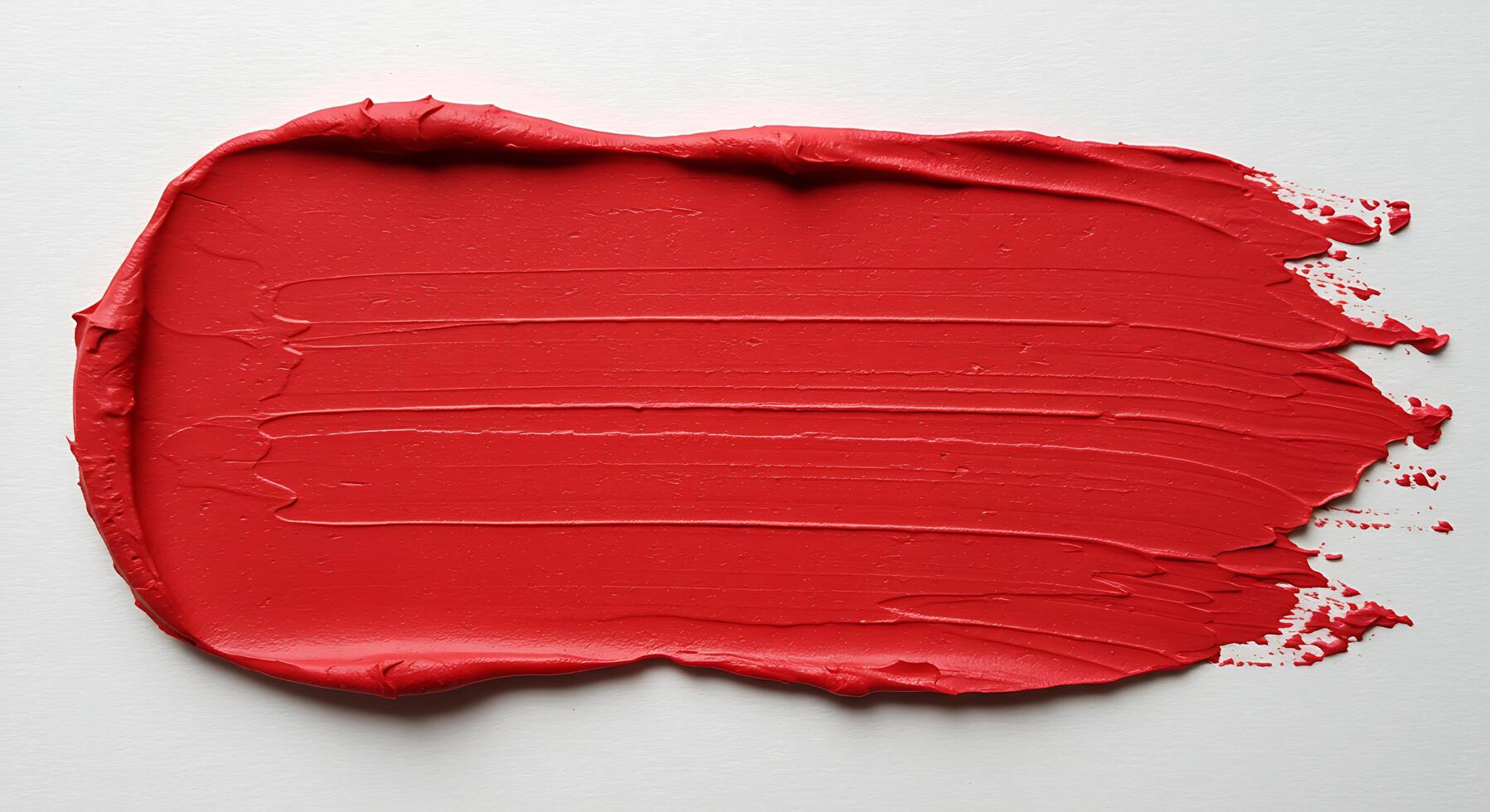 A red paint splatter on a white surface photo