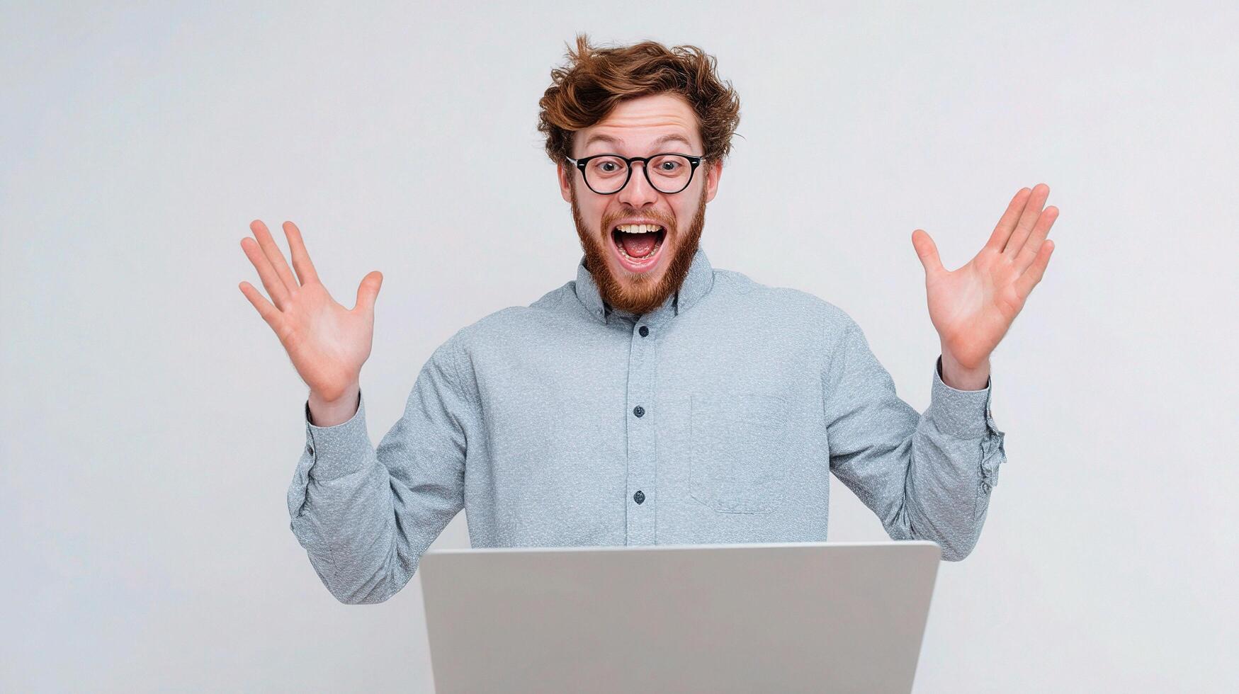 A man with glasses and a laptop is making a face photo