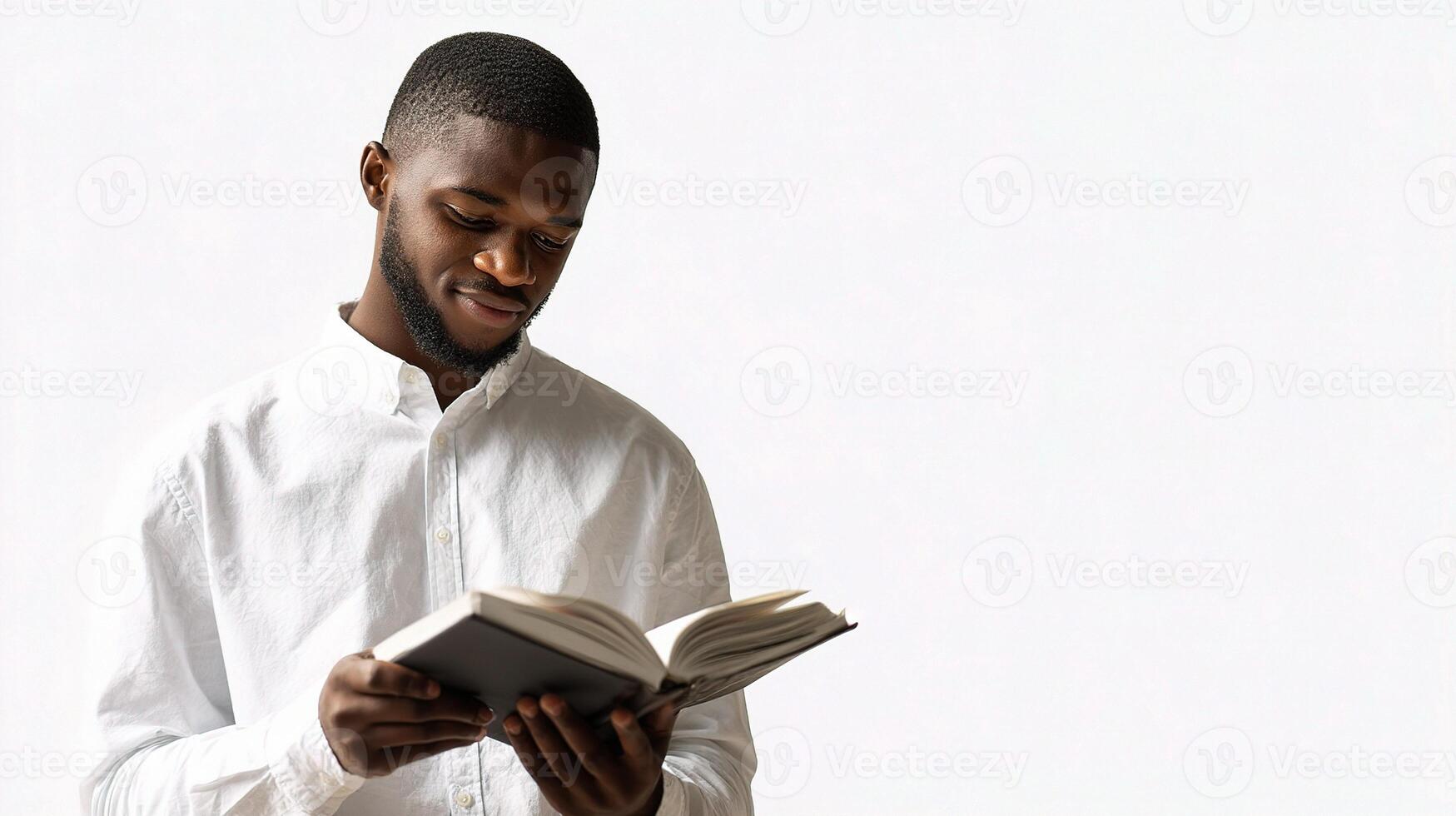 A man in a white shirt is reading a book photo
