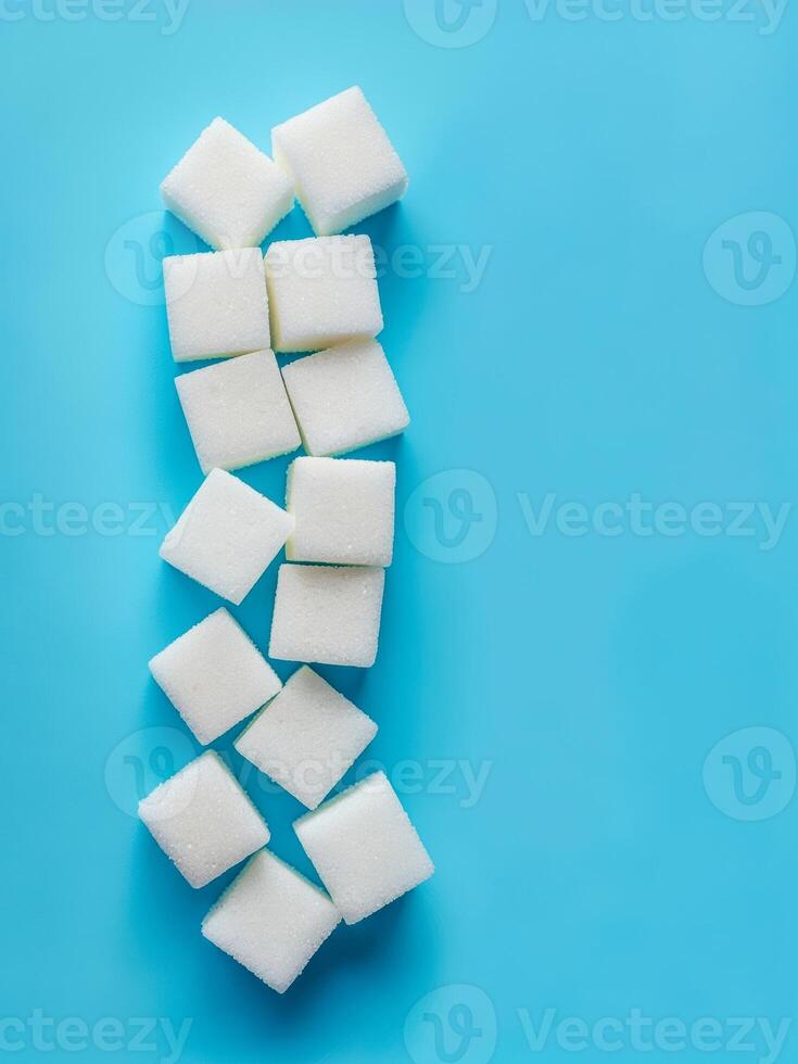 Sugar cubes arranged creatively on a bright blue surface, showcasing modern minimalism and color contrast photo