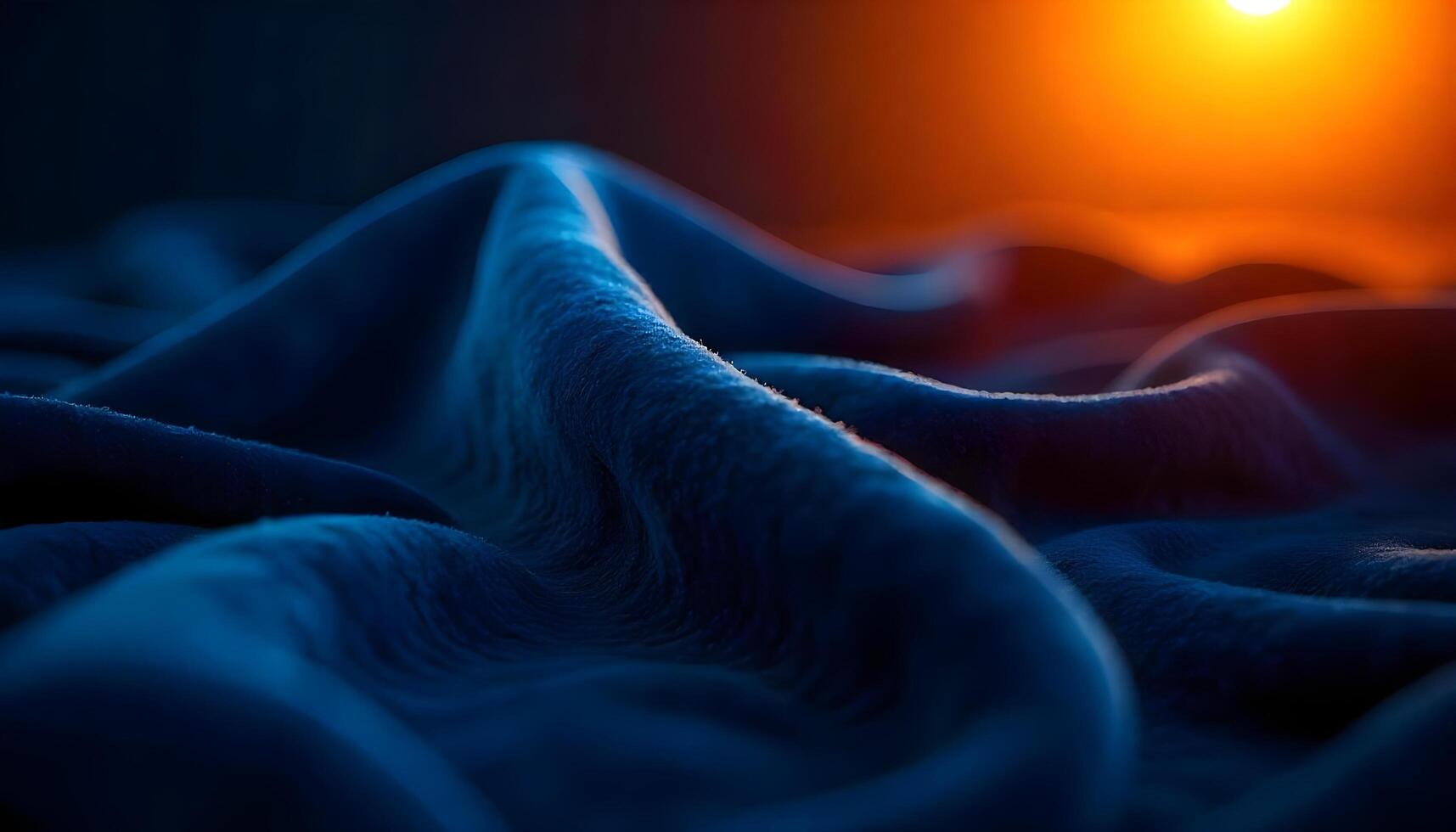A close up of a blue fabric with the sun in the background photo