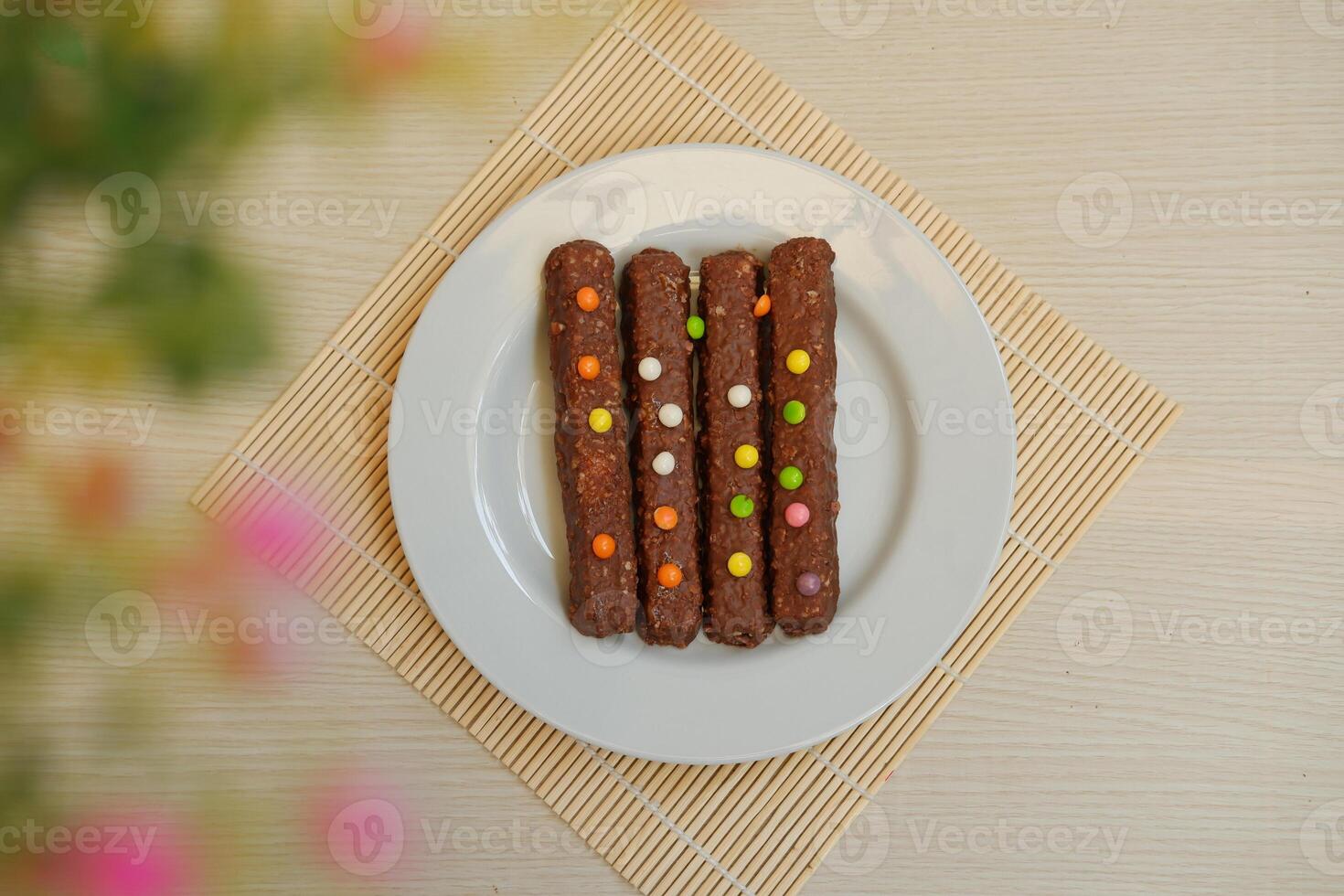 The bars appear rich and textured, likely containing nuts, oats, or crispy cereal inside the chocolate coating photo