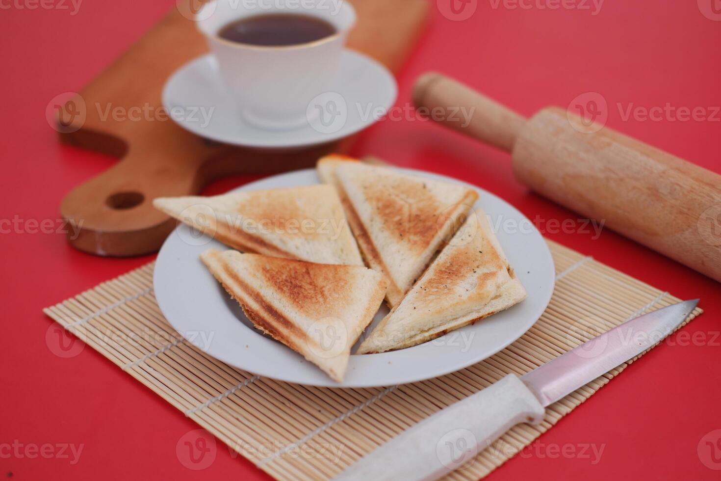 a plate of toasted sandwich triangles arranged neatly on a white plate photo
