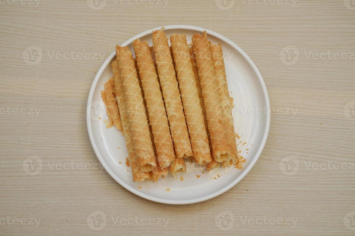 showcases a plate of crispy rolled wafer sticks photo